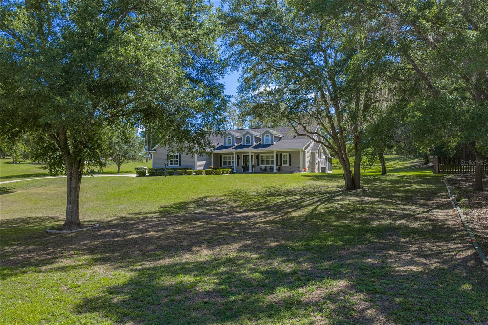 A timeless country residence set on nearly 3 scenic acres, nestled behind mature trees, and with a host of recent updates, this home is ready for its newest chapter. Located in the desirable Spring Lake area this community features a paved road, no HOA fees, underground utilities & street lights. Each of the sixteen unique homes are situated on 3-5 acres. Providing 3 bedrooms, 3 bathrooms, a 2 car garage, a 2022 roof, 2018 + 2020 AC units, a 2024 water heater, updated bathrooms, this home has been meticulously maintained and is move in ready! A peaceful setting with birds chirping, sunlight filtering through the trees, and an approach with brick pavers and classic front porch welcome you right into the home. Warm wood flooring and crown molding flow throughout the space creating easy connections and an elevated aesthetic. A wood burning fireplace, custom built-ins, French doors to the patio and high ceilings highlight the expansive living room. The kitchen features granite countertops, stainless steel appliances (including a new Subzero refrigerator still under warranty), plenty of storage, a central island, breakfast bar seating, a built-in desk nook, a large walk-in pantry, and a cozy sun-filled eat-in dinette. Near the front of the home, the formal dining room and dedicated office add extra convenience for gatherings and a private work from home space. The primary suite is separated from the guest bedrooms and offers a spacious bedroom, access to the screened back porch through French doors, an oversized walk-in closet, and an updated ensuite bathroom with 2 separate vanities, a soaking tub, and a walk-in shower. On the opposite side of the home, 2 bedrooms share a 2024 updated Jack and Jill style ensuite bathroom. The interior also provides a custom laundry room with built in clothing organizers, a 3rd full bathroom for guests, interior paint refreshed in 2021 and the installation of custom plantation shutters. Head outside through the French doors onto the brick paved and screened back porch that overlooks the lush acreage. Here you can dine alfresco, extend your living space outdoors, or simply enjoy the calm surroundings. The home features premium, low maintenance Hardie board. Several outdoor upgrades have been completed including an added storage shed, 2022 exterior paint, 2025 pumped septic tank, irrigation on the whole property, fire pit area and a 2025 gutter system. Chickens and 1 grazing animal per acre are permitted for those that want to bring their animals and take advantage of the country setting! This home is located in a place that feel tucked away but is just a short drive to local conveniences and major roadways. Give us a call today for your private viewing of Savannah Oaks.