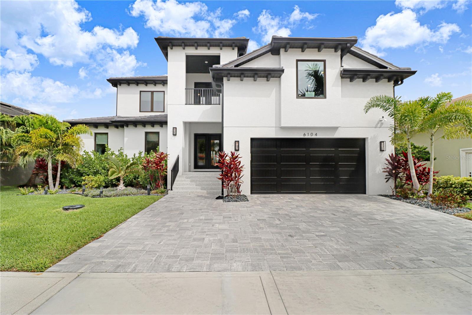 Welcome to luxury waterfront living in the exclusive community of Andalucia, where boating, recreation, and resort-style amenities come together to create an exceptional Florida lifestyle. Complete with a private marina slip, 10,000-pound boat lift, and access to an impressive collection of community amenities, this home offers a rare opportunity to enjoy one of Tampa Bay's most sought-after waterfront neighborhoods.

Built with concrete block construction all the way to the roofline and featuring 150 MPH-rated impact windows, this residence combines peace of mind with timeless elegance. Inside, you'll find luxury vinyl plank flooring throughout with **zero carpet**, custom built-in closets, and crown molding in the living room, kitchen, and primary suite. The thoughtfully designed kitchen showcases rich wood cabinetry with soft-close doors and drawers, abundant storage, a dedicated coffee bar, and a stunning 48-inch Café gas range.

Designed for entertaining, the home seamlessly blends indoor and outdoor living. The finished screened lanai features a fully equipped outdoor kitchen, a custom bar area, and overlooks the heated saltwater pool and spa with a submerged sun shelf. Upstairs, a second outdoor bar is located on the private lanai off the executive office, creating an elevated retreat perfect for entertaining guests, enjoying sunset views, or working from home in style.

Additional features include a whole-home Titan water filtration system, custom closet systems, and premium finishes throughout.

Residents of Andalucia enjoy an unmatched lifestyle with a private marina, boat ramp, country club, tennis courts, pickleball courts, and beautifully maintained community amenities. Whether you're heading out for a day on Tampa Bay, enjoying an afternoon match, or relaxing poolside at home, this property delivers the perfect blend of luxury, recreation, and waterfront living.

This is more than a home—it's a waterfront lifestyle designed for those who want the very best of Tampa Bay living.