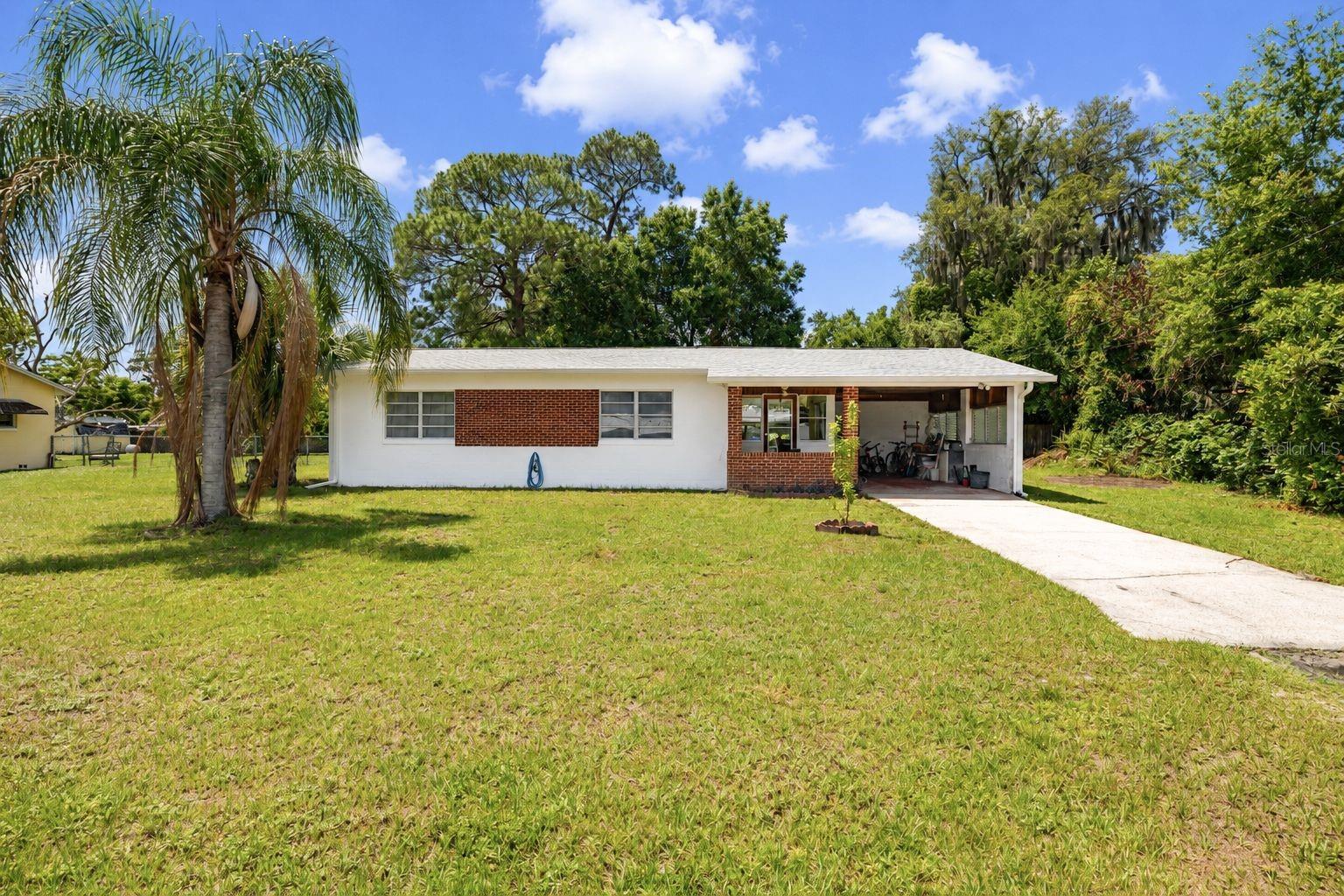 Welcome to 9 Sunset Drive — a peaceful hidden retreat where comfort, nature, and thoughtful living come together. Nestled on a generous 0.33-acre lot in charming DeBary, this lovingly maintained 2-bedroom, 2-bath residence offers a rare blend of solid timeless construction, meaningful upgrades, and the kind of peaceful energy that instantly makes you exhale.

Perfect for the nature enthusiast, gardener, creative soul, or anyone craving a slower, more intentional lifestyle, this property feels like a private sanctuary tucked away from the noise, yet conveniently close to everyday essentials.

Inside, natural light pours into the bright, inviting interior, highlighting the durable terrazzo flooring throughout and creating a warm, grounded atmosphere full of character and comfort. This home is truly move-in ready, with major updates already thoughtfully completed, including a brand-new roof (2025), updated plumbing (2020), efficient Mitsubishi split-unit A/C systems for personalized zoned comfort, and an impressive water system featuring private well water, filtration, softener, reverse osmosis drinking water, and no monthly water bill.

The heart of the home combines practicality with modern convenience, featuring quality upgrades including a 2021 AO Smith hybrid water heater, Whirlpool commercial-grade washer, double oven, and energy-efficient appliances — all chosen with longevity and comfort in mind. Even the septic system has been recently serviced (November 2024), offering valuable peace of mind.

Step outside and the magic continues. The spacious yard invites you to create your own outdoor sanctuary — imagine flourishing vegetable gardens, wildflowers, yoga mornings, a hammock beneath the trees, evenings under string lights, or even a future pool retreat. Two raised gardening beds are already in place, waiting for fresh herbs, tomatoes, sunflowers, or whatever inspires your green thumb. The charming breezeway carport adds both convenience and personality, enhancing the relaxed character of the property.

This is more than a house — it’s a place for dreamers, plant lovers, peaceful souls, and anyone who believes home should feel like a sanctuary.

A rare opportunity to own a beautifully upgraded retreat where you can slow down, breathe deeply, and truly feel at home. Located just minutes from  Gemini Springs Park, Blue Springs State Park - famous for manatees, kayaking, crystal clear spring waters, Lake Monroe Park- waterfront views, boating access, fishing and scenic sunsets, Green Springs Park, St. Johns River - access for boating, wild life watching, and eco adventures. Only minutes from DeBary Sunrail Station - convenient commuter rail access to Sanford, Winter Park, Downtown Orlando, Adventh Health Hospital, Kia center and Kissimmee. New Smyrna Beach is 40 minutes drive and Daytona Beach is 45 minutes drive.