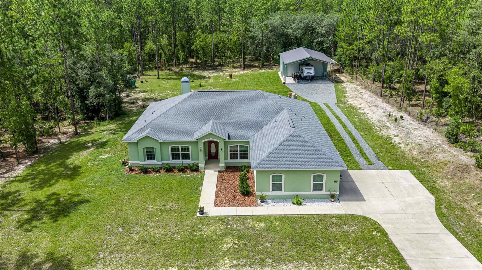 LOCATION, LIFESTYLE & QUALITY—THIS HOME HAS IT ALL!

Discover the perfect balance of peaceful country living and convenient access to everything that makes Central Florida so desirable. Ideally situated between Ocala and Dunnellon, this meticulously maintained one-owner home offers the best of both worlds—privacy and space without sacrificing convenience.

Step inside to an inviting open-concept, split bedroom floor plan featuring 10-foot ceilings, tile flooring throughout, and a cozy wood-burning fireplace that creates the perfect gathering space. Designed with comfort and functionality in mind, the home offers two spacious primary suites, each with its own full bathroom featuring wheelchair-accessibility and walk-in showers, making it ideal for multi-generational living or accommodating guests.

Outside, you'll appreciate the beautifully maintained mature landscaping, automatic irrigation system, fully fenced yard with an electric entrance gate, and a relaxing covered back porch perfect for enjoying Florida's beautiful evenings.  The current owners love the birds that visit their yard each day.  

Need room for hobbies, toys, or a home business? The impressive 20' x 40' shop is ready for your vision, prepped for electric service and an RV connection. Additional modern conveniences include a generator hookup and an EV charging station, providing peace of mind and future-ready living.

Living in Dunnellon means embracing the Florida lifestyle. Spend weekends kayaking, tubing, paddleboarding, or swimming in the crystal-clear waters of Rainbow Springs State Park and the Rainbow River, just a short drive away. Explore nearby Withlacoochee State Trail for biking and hiking, enjoy boating and fishing on the area's lakes and rivers, or discover charming downtown Dunnellon's local restaurants, shops, and community events.

When you're ready for more, you're only a short drive to Ocala, home to the World Equestrian Center, premier shopping, medical facilities, dining, and entertainment. Outdoor enthusiasts will love being close to the Ocala National Forest, while day trips to Crystal River, Inverness, and The Villages offer even more recreation, waterfront adventures, golf, and dining options.

Whether you're looking for a forever home, multi-generational living, or simply a peaceful retreat with modern conveniences, this exceptional property offers quality, comfort, and an unbeatable location. Homes cared for this meticulously don't come along often—schedule your private showing today!