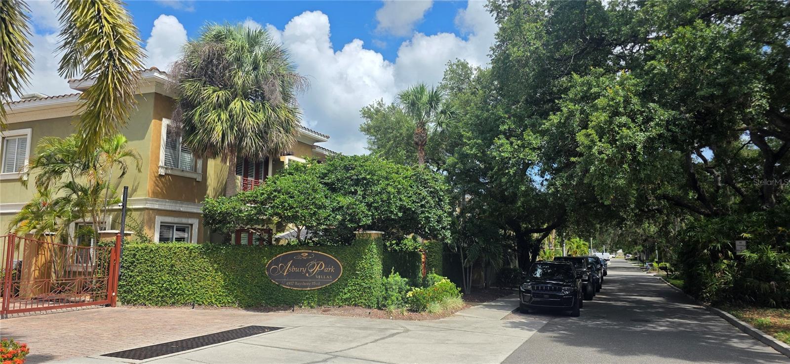 Virtually Staged. Located in the gated Asbury Park Villas community, this multi-level South Tampa townhome offers a rare opportunity to enjoy direct access to Bayshore Boulevard. Step out from your private patio and onto Tampa's iconic waterfront boulevard, where miles of walking, jogging, and biking paths stretch along Hillsborough Bay.

Inside, soaring ceilings, rich hardwood flooring, and expansive windows create a bright and inviting living environment. The open-concept floor plan is designed for both everyday living and entertaining, with spacious living areas that flow seamlessly into the kitchen and dining spaces. Generously sized bedrooms, multiple levels, and flexible living areas provide options for guests, a home office, fitness space, or additional gathering areas.

Private patios and balconies extend the living space outdoors while offering an ideal setting to enjoy the surrounding neighborhood atmosphere. Community amenities include gated entry and beautifully maintained grounds.

Conveniently located near Ballast Point Park, MacDill Air Force Base, Hyde Park Village, Downtown Tampa, Water Street, and Sparkman Wharf, this residence combines a highly desirable location with the convenience of low-maintenance townhome living and immediate access to one of Tampa's most recognizable landmarks, Bayshore Boulevard.