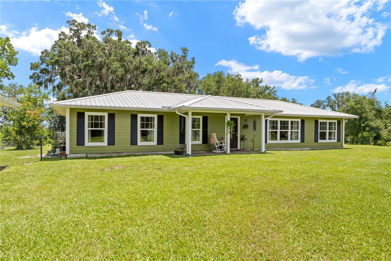**CHARMING COUNTRY HOME ON 4.1 ACRES**This charming 2 bedroom, 2 bath home is set on 4.1 peaceful acres and offers the best of country living with sunrise and sunset views in a beautiful natural setting. Bordering hundreds of acres of the Stewart Tree Farm, the property provides privacy, open space, and a true sense of tranquility. The home has been well maintained and features recent updates including new flooring, fresh interior and exterior paint, and new interior lighting in 2026. Large dining room ideal for everyday living and entertaining. Galley kitchen with abundant counter space and storage. Appliances are only 3 years old and included with the home. Two master bedroom/bath suites for comfort and flexibility. spacious living room with a welcoming layout. Interior laundry for added convenience. The property includes an upgraded metal roof on both the home and detached 2-car garage, adding lasting value and peace of mind. Enjoy relaxing or entertaining on the 15x12 screened back porch while taking in the surrounding views. The land is HIGH & DRY, zoned AG, is perimeter fenced with quality chain link fencing & gated access.  It also includes vegetable gardens with raised beds, avocado trees, and fruit trees. Daily wildlife sightings include hawks, deer, crows, and sandhill cranes, creating a setting that feels connected to nature throughout the day. With its open acreage and quiet surroundings, this property offers a serene country lifestyle with scenic beauty in every direction. Located in the desirable Croom area, this home is just a few miles from the Withlacoochee State Forest, a favorite destination for nature lovers, hikers, and equestrian enthusiasts. Nearby Silver Lake Recreation Area offers hiking, boating, and lake camping, while Tucker Hill provides access to the Croom Trailheads for biking and horseback riding. Enjoy the convenience of nearby city amenities along with Spectrum TV and high-speed internet availability.