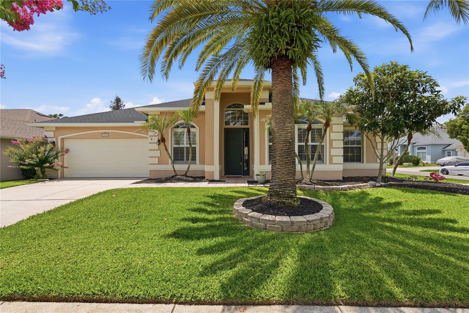 This is the home where every weekend feels like a getaway! The backyard is a tropical oasis, fully fenced with a resort-style pool, and the home is move-in ready with four bedrooms and three baths on a corner lot in the amenity-rich community of Waterford Lakes. Whether you are hosting a crowd or relaxing with your morning coffee, the backyard is your own private paradise. The pool is wrapped in flagstone with a waterfall feature, alongside a spacious covered lanai with a tongue-and-groove wood ceiling overhead. Inside, it is open and bright with soaring ceilings. The kitchen features a large quartz center island to cook, work, and gather around, plus white cabinets, a tile backsplash, and upgraded appliances including built-in double ovens and a Samsung Bespoke refrigerator. The family room and its cozy fireplace anchor the open floor plan, with views to the backyard through oversized sliders and large windows by the breakfast nook. The three-way split floor plan is ideal. The primary suite sits on its own side of the home with high ceilings and sliding doors straight out to the lanai, while the other bedrooms are tucked away on the opposite side for privacy. One of the guest baths even doubles as a pool bath, so wet feet stay outside. Up front, a flex room with glass barn doors and an arched window gives you a true office, gym, playroom, or den. And the big work is already done here. New roof in 2024, a whole-home repipe in 2024, and the HVAC and water heater both updated in 2020, plus a refreshed kitchen and updated flooring throughout. The Waterford Lakes community gives you plenty to do, too: tennis, pickleball, basketball, racquetball, volleyball, baseball, and soccer, plus two gated dog parks, a full-size lap pool, a shaded playground, and a walking track. And the location is hard to beat. You are right in East Orlando's Alafaya corridor, minutes from Waterford Lakes Town Center, UCF, and the 408 and 417 for an easy commute in any direction. Call today for your private showing!