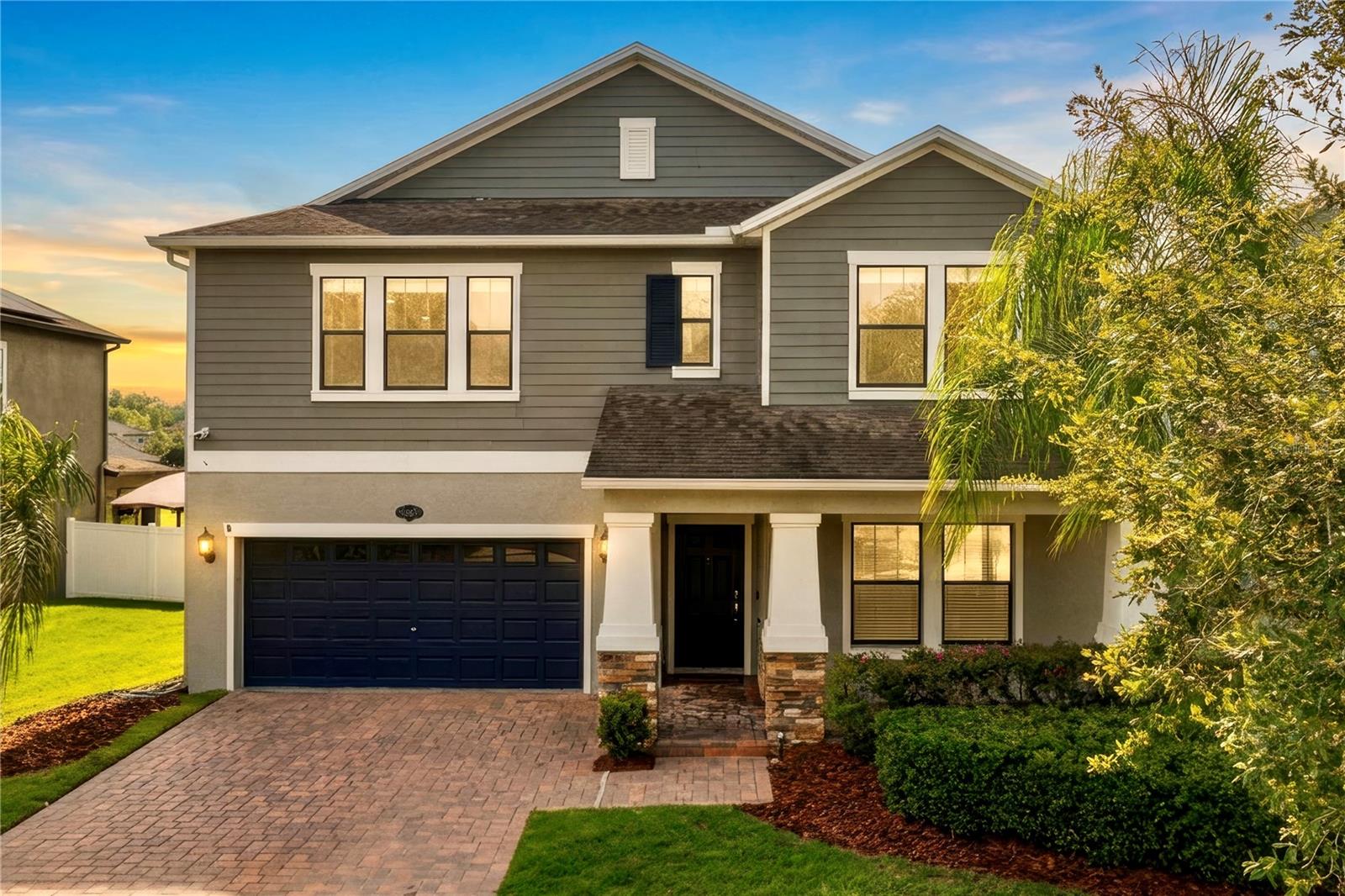 With 3,822 square feet of living space, a 3-CAR TANDEM GARAGE, and peaceful pond views, this MOVE-IN READY 5-bedroom, 3.5-bath Craftsman-style home offers exceptional flexibility and comfort in the gated community of Heron Preserve at K-Bar Ranch. The VERSATILE FLOOR PLAN features a FIRST-FLOOR PRIMARY SUITE for comfort and privacy, an OPEN-CONCEPT LIVING area filled with natural light, and an upstairs layout designed to give everyone their own space - IDEAL FOR GROWING OR MULTI-GENERATIONAL FAMILIES. Curb appeal is enhanced by an inviting front porch with stone accents, rich contemporary exterior colors, and an oversized paver driveway with generous parking. The kitchen is designed for everyday living and entertaining, featuring 42-inch cabinets, stone countertops, stainless steel appliances, a butler's pantry, an oversized walk-in pantry, and a convenient coffee bar and workstation, all overlooking the SPACIOUS LIVING AND DINING AREAS. A flexible front room is perfect as a home office, formal dining room, or gym. A first-floor laundry closet offers endless possibilities, whether used for a stackable washer and dryer, extra storage, or a custom wine cellar. Upstairs provides 4 SPACIOUS BEDROOMS, each with a WALK-IN CLOSET, 2 full baths with dual vanities, and a large laundry room complete with cabinetry and a utility sink. An EXPANSIVE BONUS ROOM with recessed lighting is ideal as a theater room, game room, or playroom, and can easily be enclosed to create a 6th bedroom. Relax on the screened lanai while enjoying tranquil pond views and a FULLY FENCED BACKYARD with plenty of ROOM FOR YOUR DREAM POOL. Notable upgrades include a new water heater (2026), REME Halo air purification system, whole-house surge protector, whole-house water filtration system, crown molding, shiplap accent walls, a renovated guest bathroom, and pre-wired security system. Residents enjoy exclusive access to Heron Preserve's private playground and dog park, plus K-Bar Ranch's resort-style amenities including a community pool, recreation center, tennis courts, and basketball courts. Conveniently located in the heart of New Tampa, you'll enjoy easy access to I-75, I-275, USF, shopping, dining, hospitals, Wiregrass Mall, Tampa Premium Outlets, and downtown Tampa. Heron Preserve is also the only community within K-Bar Ranch offering dedicated bus pickup and drop-off from the A-RATED Pride Elementary SCHOOL. A rare combination of size, flexibility, upgrades, and location makes this an exceptional place to call home.