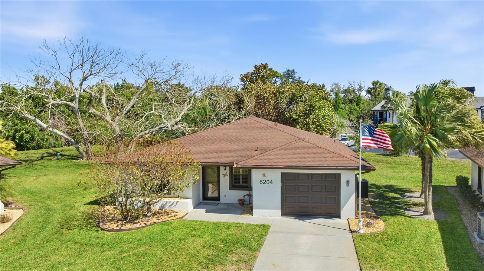 Virtually Staged. Welcome to easy Florida living in Cambridge Village West.  Tucked away on a quiet cul-de-sac in this 55+ community, this charming 2 bedroom 2 bath home offers comfort, great upgrades and a relaxing lifestyle.  The 2024 freshly painted exterior and well kept landscaping create inviting curb appeal. Inside you'll notice very attractive wood laminate floors that flow throughout the house.  The living space which is bright and welcoming opens to the back where sliding glass doors lead to an extra large 10' x 24' air conditioned Florida room for year round comfort. Upgrades include a 2022 air conditioner, 2024 hot water heater, 2025 LiftMaster garage door, 2022 gutters and downspouts  and whole home surge protector wired directly into the electrical panel system.  Residents that live here enjoy socializing and making new friendships when gathering at the Clubhouse with its kitchen, library, heated pool, shuffleboard courts and outdoor grilling area.  Monthly fees are an OUTSTANDING $293 a month which includes cable, Wi-Fi, community amenities and maintenance of the lush landscaping that adds to the appeal of this neighborhood. Best of all, you're just 5 miles from Bradenton's beautiful famous beaches and conveniently close to shopping, restaurants and literally right down the road from LC Blake Hospital. This may be exactly what you've been waiting for!