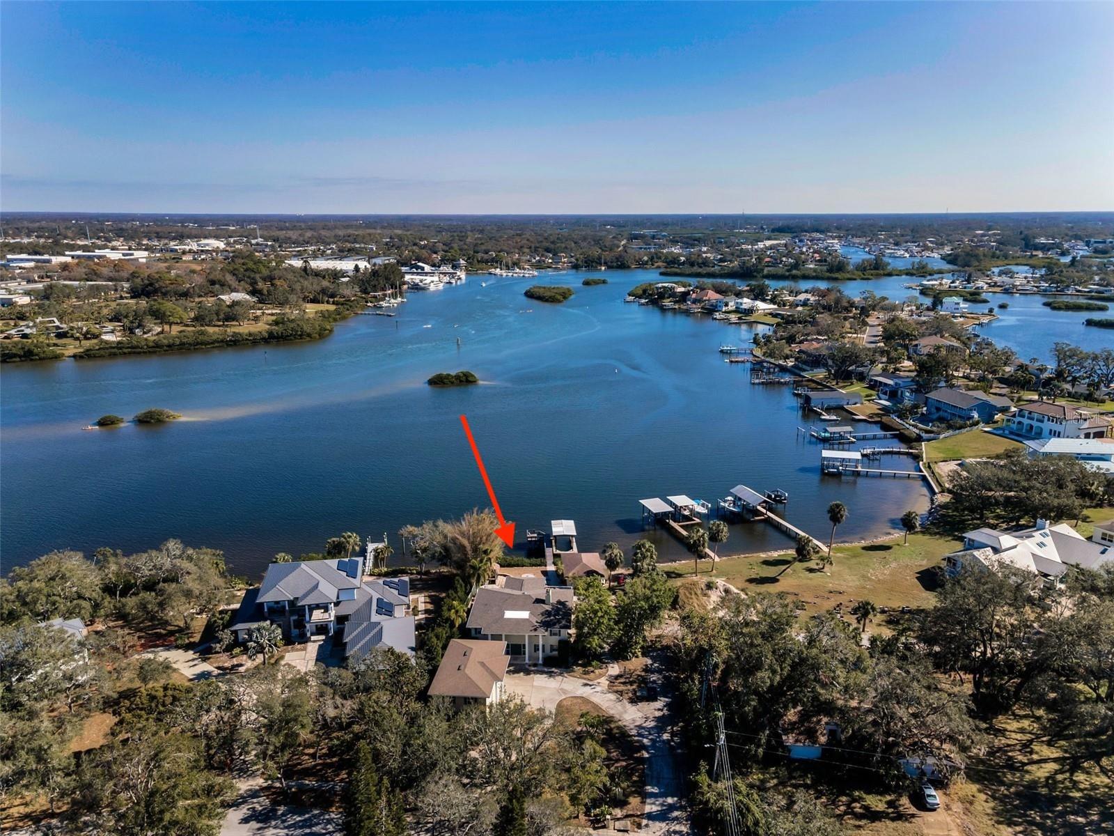 Accepting reasonable offers. SELLER MOTIVATED!!!   
 DOLPHIN COVE ESTATE – A Once-in-a-Lifetime Waterfront Opportunity in Historic Tarpon Springs. Truly unparalleled and exceptionally private, this extraordinary riverfront estate is comprised of three detached residences, each offering independent living and private access—an incredibly rare offering in North Pinellas County. Ideally positioned on the most desirable stretch of the Anclote River and located in Flood Zone X with no flooding to any structure, this remarkable property delivers both peace of mind and breathtaking natural beauty.
The main residence features 4 bedrooms and 4 baths (3 full, 1 half) with expansive, traditional living spaces rarely found in today’s construction. Soaring room sizes, elegant finishes, two fireplaces (living and family rooms), plantation shutters on the first floor, and custom built-ins create a timeless and refined interior. The chef’s kitchen is a true showpiece, boasting top-tier appliances, stone countertops, and distinctive honey marble flooring, perfectly designed for both entertaining and everyday luxury.
The second structure is a fully equipped boathouse/in-law residence complete with its own kitchen, bath, and private entry—ideal for multigenerational living, guests, or long-term income potential. The third structure offers a three-bay garage with a private-entry, rough-plumbed second-floor apartment, ready to be transformed into a luxury guest suite, studio, or executive office retreat.
Step outdoors to a custom-designed resort-style pool framed by dramatic boulder landscaping and lush surroundings, setting the stage for outdoor entertaining with absolute privacy. From nearly every room, enjoy sweeping water views of river frontage, distant marinas, and protected islands that serve as a sanctuary for dolphins, manatees, eagles, and exotic shore birds—a living work of art that changes with every season and tide.
This estate delivers an unmatched sense of tranquility, prestige, and connection to nature while being moments from the charm, dining, culture, and waterfront lifestyle of Historic Tarpon Springs. Properties offering this level of privacy, versatility, elevation, and natural beauty are exceedingly rare.? A legacy estate offering extraordinary lifestyle, income potential, and irreplaceable waterfront views—Dolphin Cove is simply unforgettable.