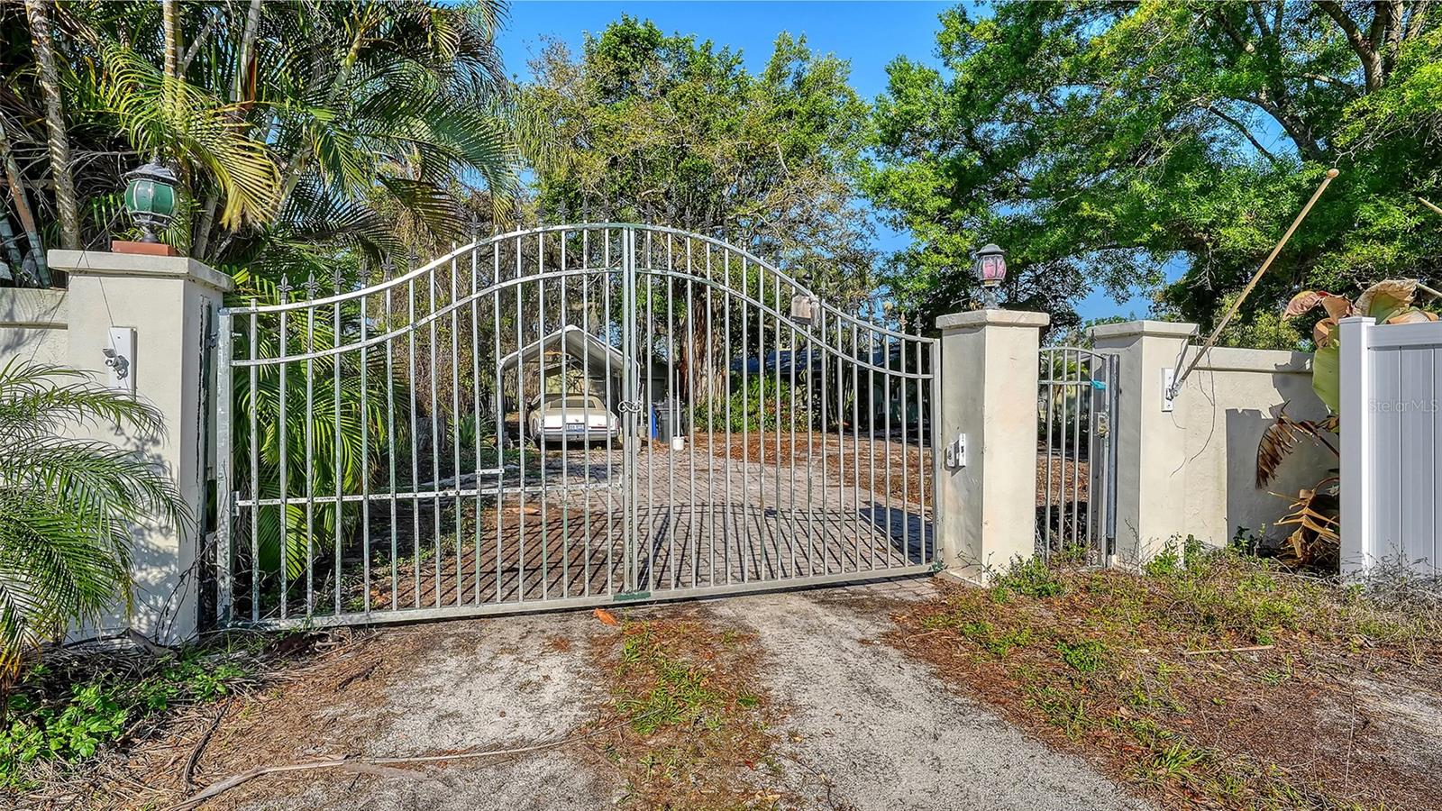 This home has been vacant for a short period of time since the owners passing.  Rare waterfront estate situated on over 1 acre of beautifully landscaped grounds.  On 225 Ft of canal frontage with direct boating access.  Private dock and boat ramp perfect for boating, fishing, and waterfront recreation.  Spacious 2,866 SF residence featuring 5 bedrooms and 3 bathrooms.  Flexible floor plan includes a private in mother-in-law suite with separate entrance.  Expansive detached garage and 16' X 38' workshop ideal for hobbyists, contractors and car enthusiasts.
Gated entrance provided privacy and security.  Fully fenced property with ample room for RV's, boats, equipment, or future expansion.  Bright and inviting living spaces designed for comfortable family living and entertaining.  Cozy fireplace creates a warm and welcoming atmosphere. Plenty of space to add a custom pool and outdoor entertainment area.  No HOA restrictions, offering maximum flexibility for your lifestyle.  Conveniently located near I-75 shopping, dining, schools, and the Gulf Coast's world class beaches.