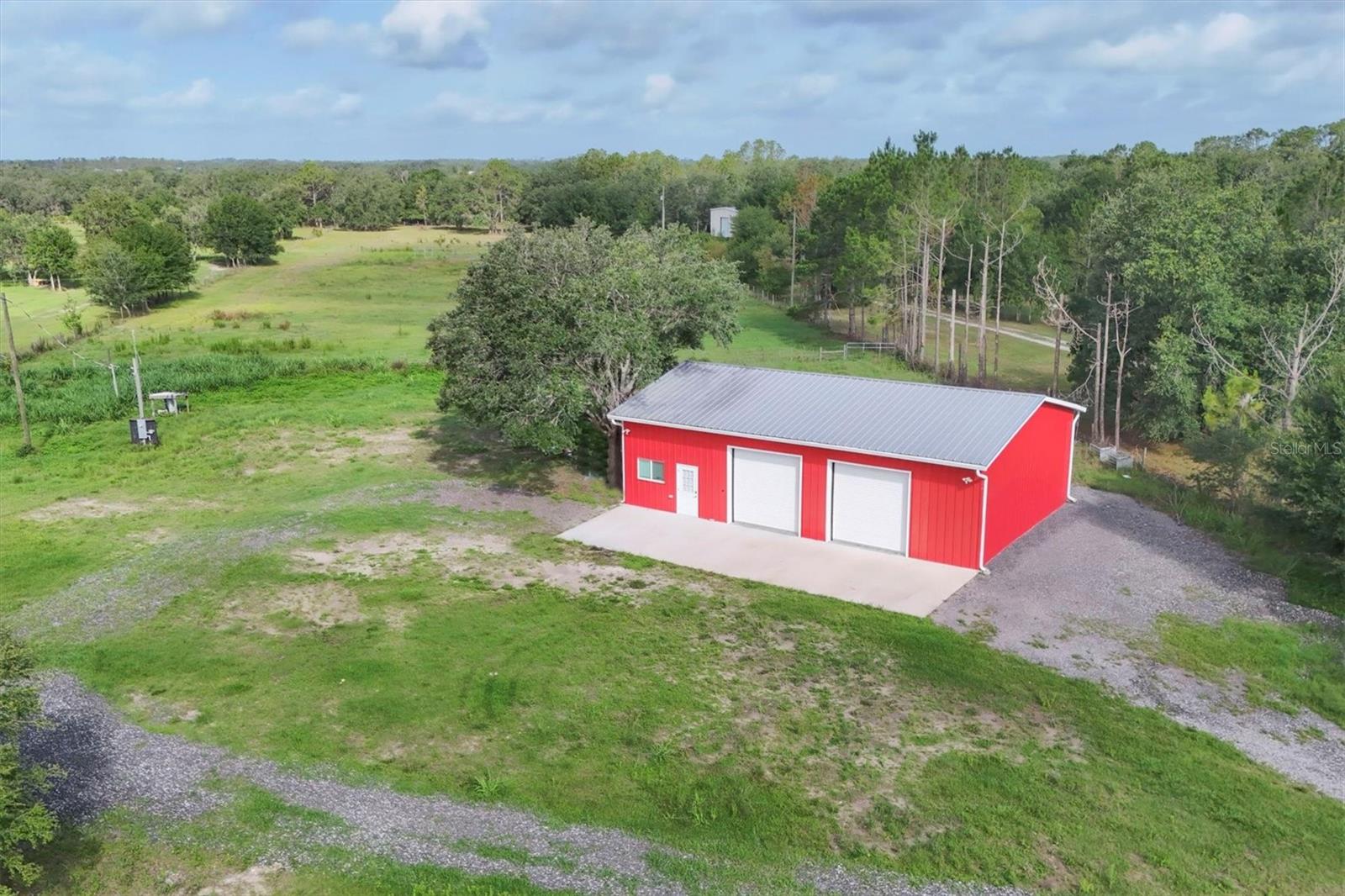 Back on the market due to Buyer's financing falling through.  Here's your 2nd chance to own nearly 10 acres of secluded, partially cleared land featuring breathtaking views, two ponds, and endless possibilities for your dream home, mini farm, equestrian estate, recreational retreat, or investment.  No HOA and no deed restrictions.  With electric, water, septic, and high-speed internet already in place, much of the groundwork has been completed. Whether you're ready to build immediately or enjoy the property while planning your future residence, this unique offering provides flexibility that is increasingly difficult to find.  The property features an approximately 1,500 SF metal garage/workshop with three 10-foot overhead bay doors, offering ample space for vehicles, boats, trailers, farm equipment, recreational vehicles, or hobbies. A new septic tank was installed in 2023, and approximately 400 SF of the building was professionally converted into air-conditioned office/flex space complete with a full bathroom and washer/dryer hookups. The office area is fully insulated, including the ceiling, and additional storage is still available above the finished space. Approximately 1,100 SF of workshop/warehouse space remains.  Two fenced and cross-fenced pastures ideal for livestock or horses!  While portions of the rear acreage may hold water during periods of heavy seasonal rainfall, this property is flood zone x (no flood insurance required).  According to the previous owner, the larger pond was excavated to approximately 32 feet deep to promote drainage, stormwater management, and healthy fish habitat. This spring-fed pond is stocked with bass and bluegill, while the second pond serves as a livestock pond. Wildlife enthusiasts will appreciate frequent sightings of deer, wild turkeys, monarch butterflies, and a variety of native bird species, including migrating bluebirds.  Outdoor recreation opportunities abound, with Duette Preserve located less than one mile away and accessible via Logue Road. Spanning more than 21,000 acres, Duette Preserve is the largest preserve in Manatee County and offers extensive riding trails, wildlife viewing, hunting opportunities, and access to the headwaters of the Manatee River.  Enjoy the peace and privacy of country living while remaining within convenient reach of Lakewood Ranch, Sarasota, shopping, dining, golf, and entertainment. Subsurface rights included. May be available for lease or lease purchase depending on the terms, ask for details.