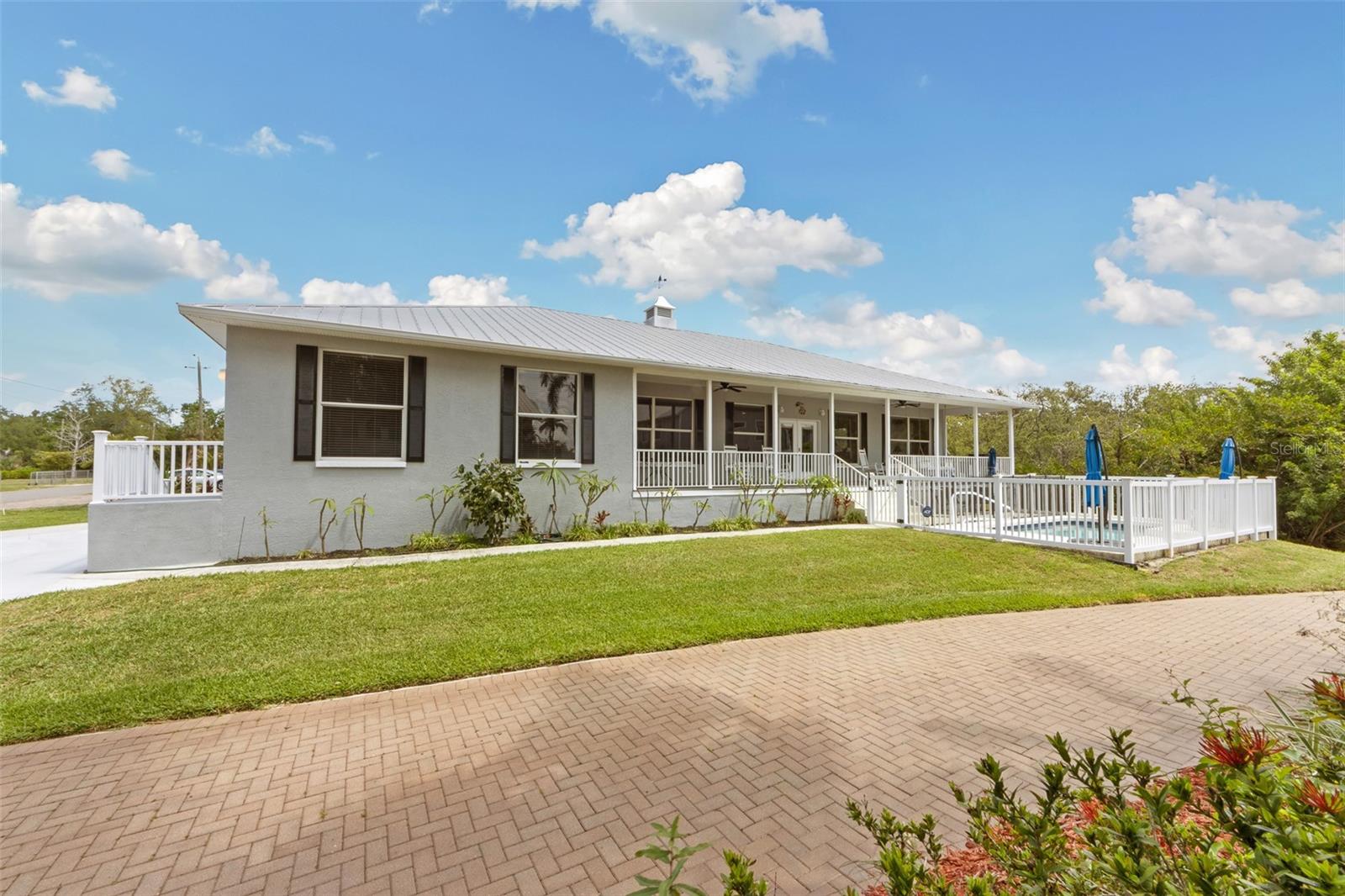 Live the Palmetto River District lifestyle with sweeping Manatee River views from your front porch, pool, and many of the rooms in this custom 2004 home at 310 13th Ave W. Thoughtfully designed for flexibility, the layout works beautifully as a 3-bedroom arrangement, offering an ideal setup for a teenager, college-age child, multigenerational living, or long-term guests who need extra privacy. Light-filled living areas, warm finishes, and Old Florida character create a welcoming feel the moment you step inside, while a private suite with its own entrance and living area adds incredible versatility for family, guests, or a dedicated work-from-home space. Outdoors, a sparkling pool, covered patio, and lush landscaping combine with the river views across the street to deliver a true everyday-vacation vibe. All of this is set in a walkable West Palmetto neighborhood close to marinas, parks, dining, and downtown Bradenton—something today’s new construction communities simply can’t replicate at this price. If you’ve been waiting for a river-view pool home with personality, views, and flexible space, this is the one to see.