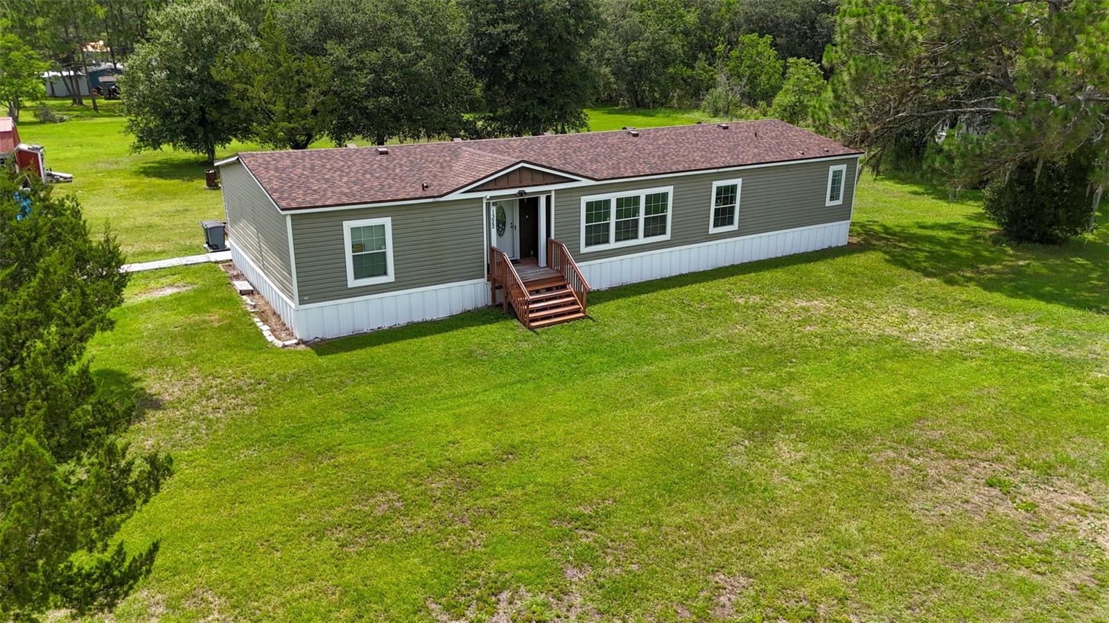 Situated on 2.27 private acres in Bunnell, this very well maintained 4-bedroom, 2-bath manufactured home offers the space and freedom that is increasingly hard to find. A new roof was installed in May 2026, adding valuable peace of mind for years to come. The property provides plenty of room for ATVs, recreational vehicles, boats, and outdoor equipment, along with the ability to fully enjoy true country living with more space than many surrounding properties.

A nice back deck just off the rear door overlooks the open acreage, creating a peaceful setting to relax and take in the natural surroundings. Inside, the home features a functional and comfortable layout with generous living areas designed for everyday use.

A whole-house Generac generator adds valuable peace of mind, providing reliable backup power during storm season and unexpected outages. Additional upgrades include a whole-house water softener system and a reverse osmosis drinking water system installed under the kitchen sink supplying purified water to the refrigerator for drinking and ice. The property is served by a private well, offering the benefit of no monthly water bill. Two exterior storage sheds provide ample space for tools, lawn equipment, and recreational gear.

Enjoy the privacy of rural living while still being approximately a 20-minute drive to nearby shopping centers, dining, and everyday conveniences, with Palm Coast and Flagler Beach within an easy commute. This property offers acreage, no HOA restrictions, and a lifestyle centered around space, privacy, and flexibility.