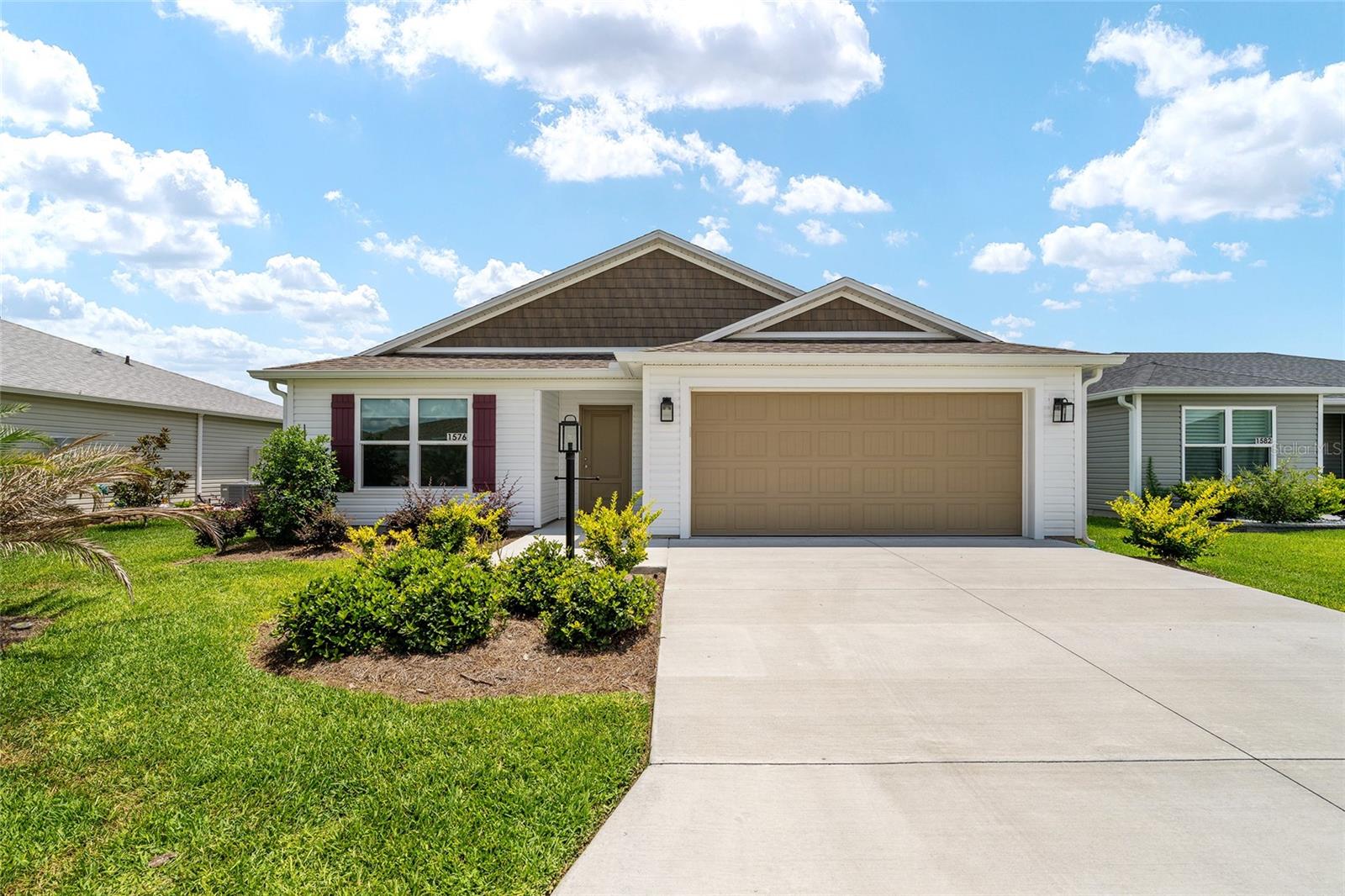 Welcome to this beautifully upgraded 3-bedroom, 2-bath Cottage Villa (fenced yard) in the highly desirable Village of Well Point in The Villages. Built in 2024 and situated on an oversized fenced homesite, this home offers the perfect blend of modern design, privacy, and convenience.

Step inside to discover an open-concept floor plan featuring spacious living, dining, and kitchen areas designed for effortless entertaining and everyday comfort. The kitchen showcases quartz countertops, stainless steel appliances, upgraded hardware, soft-close cabinet features, and abundant cabinetry.

The thoughtfully designed primary suite with volume ceilings easily accommodates a king-size bed and features walk-in closet along with an ensuite bath offering dual vanities and continued quartz countertops. Two additional bedrooms with closets provide flexibility for guests, office space, or hobbies.

Upgrades include gutters, whole-house shutters, blinds, ceiling fans, water filtration system, landscaping and more. The home features a gas stove and tankless water heater. Enjoy indoor-outdoor Florida living with a spacious screened lanai overlooking the oversized fenced backyard — offering exceptional privacy and room to relax, entertain, or let pets play freely. Washer and dryer convey with the home for added convenience.

Additional highlights include a 2-car garage and interior laundry room. Ideally located steps from the St. Tropez Recreation Center and just minutes from golf, dining, and entertainment. Conveniently located only 1.7 miles from the exciting new Eastport Town Square and a short golf cart ride to shopping at Magnolia Plaza or dining and nightly entertainment at Sawgrass Grove.

This nearly new villa combines style, upgrades, location, and an oversized fenced yard — a rare find in The Villages!