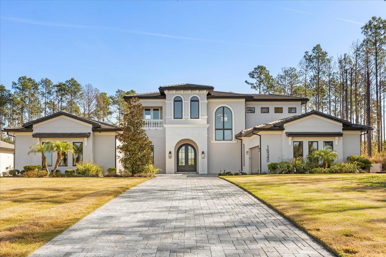 Move-in ready two-story custom home on a one acre preserve homesite in the exquisite guard gated golf community of Bella Collina. Upon entering this home you are greeted with a semi-formal entry that opens to the expansive great room with an abundance of light coming through the 5 panel sliders that overlook the pool and lanai areas. The custom designed gourmet kitchen with wood trim accents throughout boasts a large island overlooking the great room.  Appliances include Thermador 6 burner gas range, custom built hood,   fridge with matching front cabinet facing, pot filler, oversized walk-in pantry, and large breakfast nook in addition the formal dining room and dry bar area. A corner wine wall adds the elegance of the great room. The first-floor primary bedroom offers an owners coffee bar with beverage fridge. Large bay windows stream plenty of natural sunlight with a sitting area overlooking the pool and lanai. The ensuite bathroom features dual side entry shower with two rain heads, double vanity, soaking tub and two walk in closets. Three additional bedrooms and loft on the second floor are perfect for additional family members or guests. The oversized lanai and backyard living areas are ideal for entertaining with several covered sitting and dining areas and remote-controlled screens. The outdoor kitchen and grilling areas have plenty of counter space, a fridge with sink and easy access to the main kitchen. A 1st floor office can also double as a guest room. The club at Bella Collina offers year-round culinary and social activities for all ages. . Enjoy a round of golf on the Nick Faldo designed golf course or wind down at one of the restaurant terraces. Additional amenities include Har-Tru tennis facility, pickleball., outdoor pool complex, spa and fitness center with an array of complimentary fitness classes. Call today to learn more about this incredible home at Bella Collina. Furniture is negotiable.