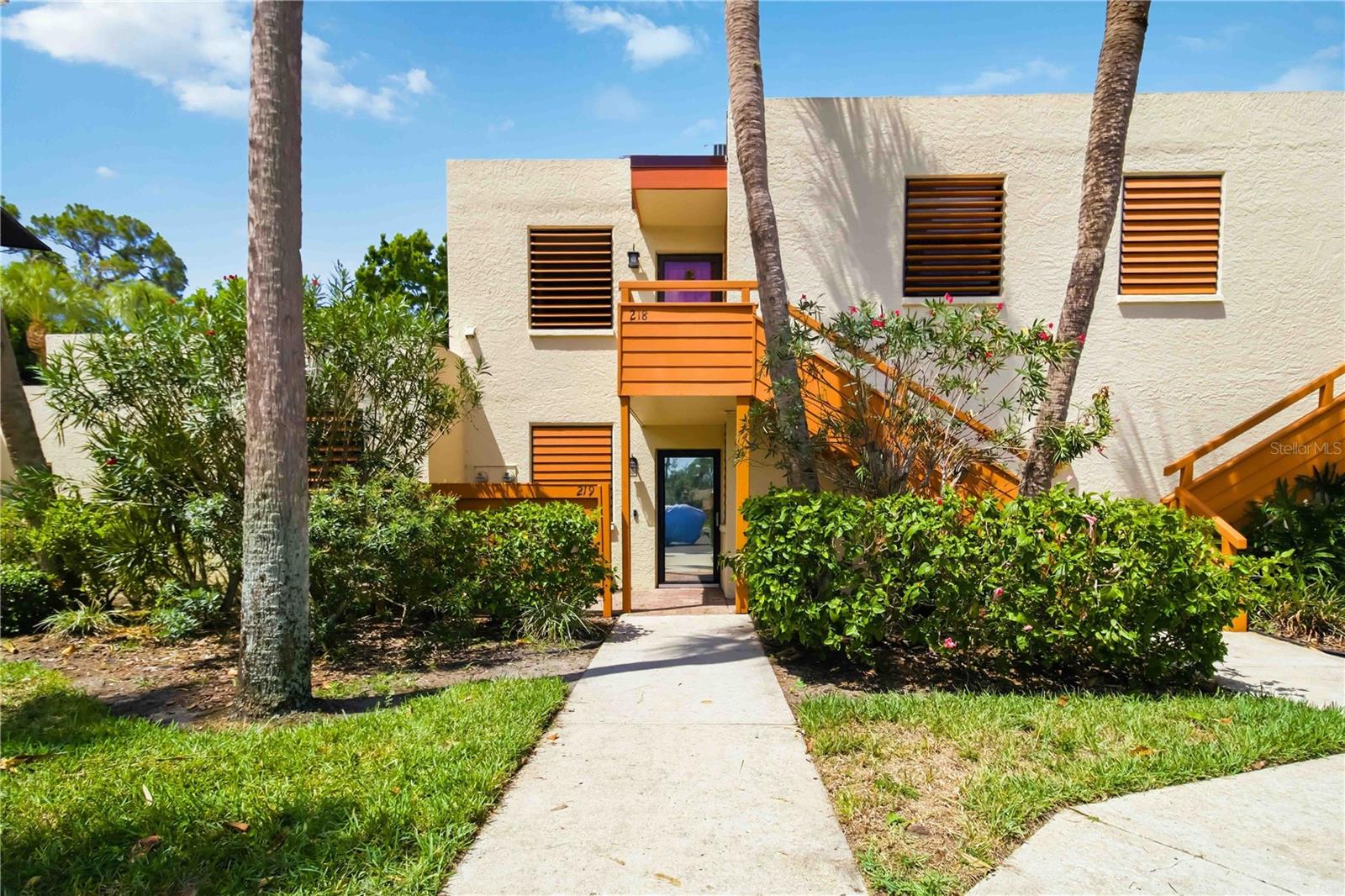 Tucked among the lush landscaping of Wildewood Springs, this beautifully updated upstairs condo feels fresh, stylish, and move-in ready. The two-bedroom, two-bath layout features neutral luxury vinyl flooring throughout—no carpet—and both bedrooms have their own ensuite bathrooms.

The renovated kitchen includes new cabinetry, quartz countertops, stainless steel appliances, and a coastal-inspired backsplash. Thoughtful design details give the home plenty of character, including shiplap in the guest bathroom, custom wall paneling in the living room and primary bedroom, and modern light fixtures throughout. Both bathrooms have updated vanities and mirrors, while the primary bath also features a stylish vessel sink and glass shower doors.

The spacious, window-enclosed lanai overlooks mature trees, providing a peaceful and private setting. Currently used as a home office, it connects to both the living room and primary bedroom through sliding glass doors. The space is easily cooled by the home’s HVAC system, allowing the doors to remain open and making the lanai feel like a natural extension of the living area.

A new roof adds extra peace of mind. Wildewood Springs is a lush, beautifully maintained bird sanctuary offering heated community pools and spas, tennis and pickleball courts, and scenic walking paths surrounded by mature tropical landscaping. Conveniently located near IMG Academy, shopping, dining, and everyday essentials, the community is also just a short drive from the beautiful beaches of Anna Maria Island.