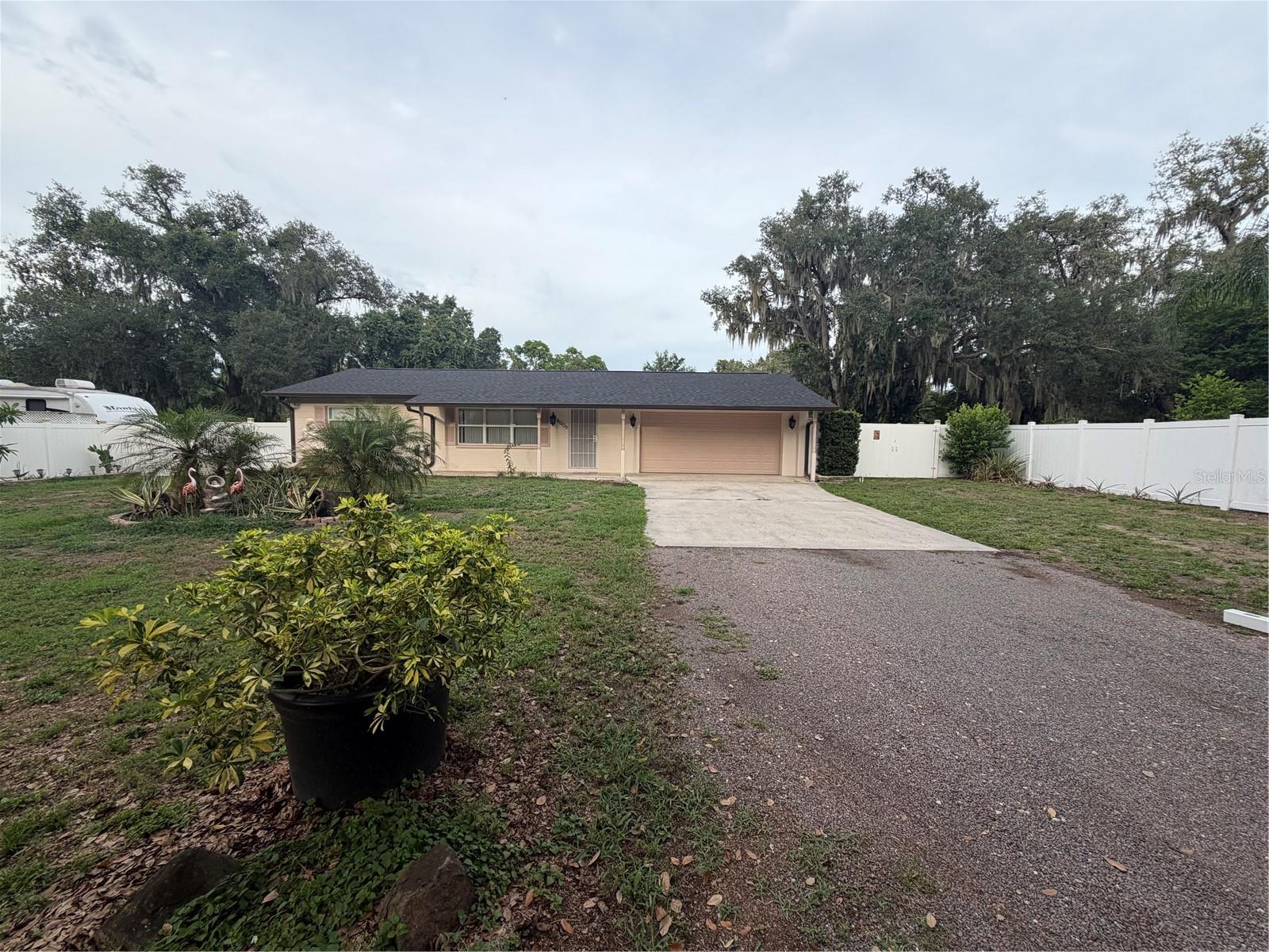 If you're looking for outdoor space, you've found it. Charming ranch style home sits on an oversized lot measuring nearly a half-acre. This adorable home has everything you are looking for, beautiful outdoor kitchen and all the amenities to enjoy with friends and family, a 2-car garage has been added, and the 1/2 bath is pre-plumbed for an easy conversion to a second full bath. The backyard is fenced for privacy and features a 2-tiered paved patio that is perfect for enjoying the Florida weather and entertaining, with a large yard surrounding that you won't find anywhere else. Don't miss out, make an appointment to view this adorable home today. New roof, water filtration system in excellent condition, new insulation.