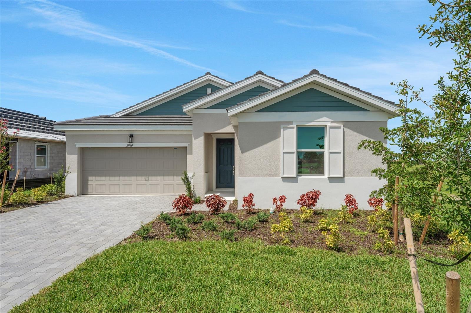 Virtually Staged. The Ravenna floorplan offers 2,088 square feet of thoughtfully designed single-story living. This spacious home features 3 bedrooms, 2.5 bathrooms, and a 3-car garage, combining comfort and functionality in a stylish layout. The open-concept design includes a large family room, dining area, and a gourmet kitchen with a center island and walk-in pantry—perfect for entertaining or everyday living. The primary suite serves as a private retreat with a luxurious bathroom and an expansive walk-in closet. Two additional bedrooms share a full bath, while a convenient half-bath is ideal for guests. A covered lanai extends the living space outdoors.