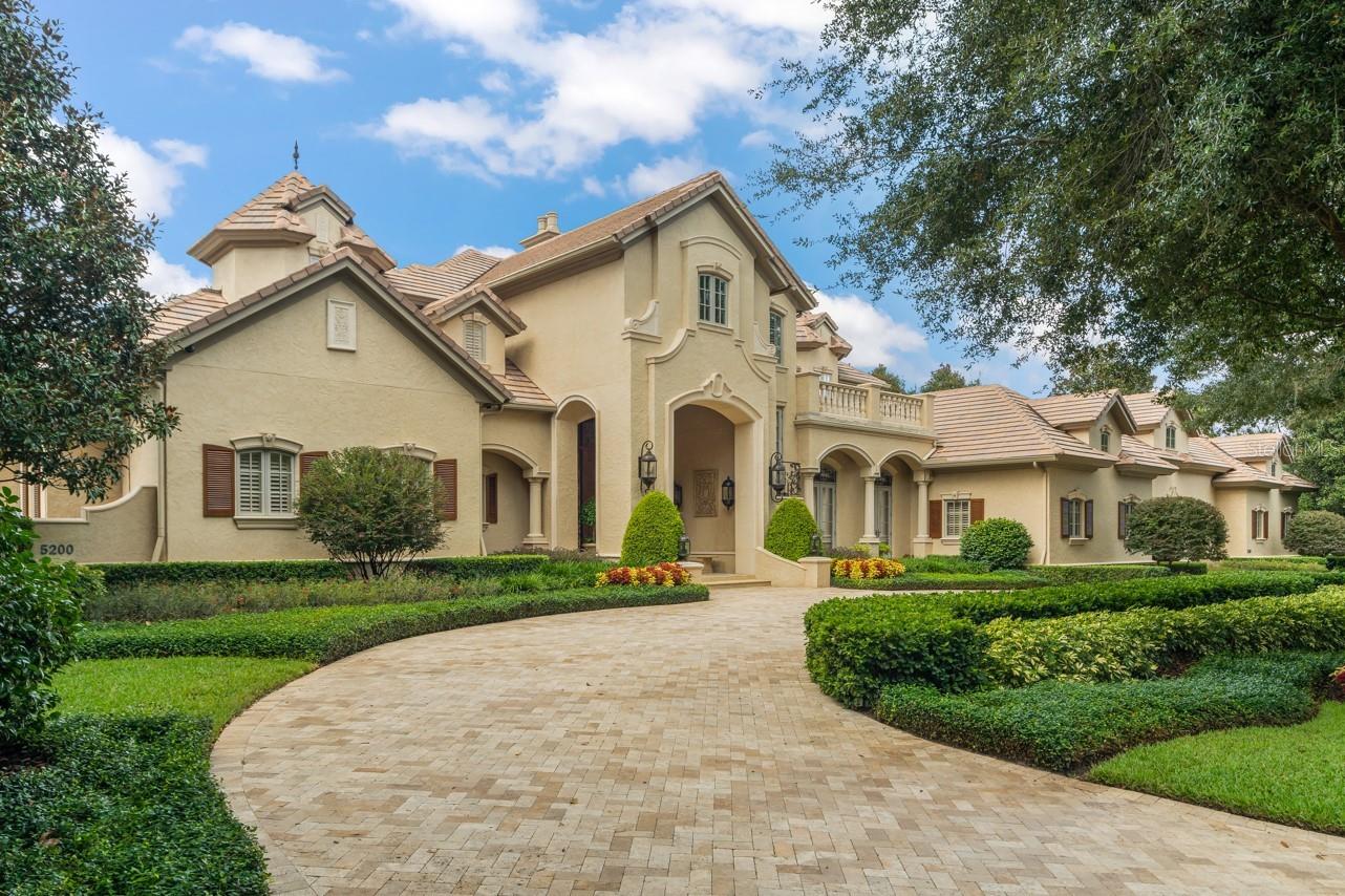 This stunning, meticulously-maintained estate, now featuring a new price, comes complete with top-tier amenities as a turnkey sale, inviting immediate occupancy and delight. Attention to detail is paramount. This home is primed with all the essential features and adorned with classic heirloom and antique furnishings, exquisite art, and notable pieces such as a Yamaha Baby Grand Disklavier Piano. The well-appointed theater, featuring an array of autographed movie memorabilia, creates a cinema-like experience for enjoying your favorite movie, sporting event or interactive video games.  A recent renovation in March 2022 by ‘Paradise Pools by Design’ has transformed the pool and spa into a relaxing oasis. The home boasts a whole house generator, a comprehensive automation system with a Lutron Lighting System, Nuvo Sound System, and state-of-the-art security and alarm systems, all accessible via wireless controls for convenience. This seamless transition into a comfortable lifestyle is further enhanced by the captivating sunset views overlooking Lake Bessie and the 8th fairway of the esteemed Isleworth Golf and Country Club. This turnkey luxury estate offers a complete sanctuary ready for immediate enjoyment. Your personal belongings are the only missing piece in this extraordinary equation, as everything else stands poised and ready for you to settle into.