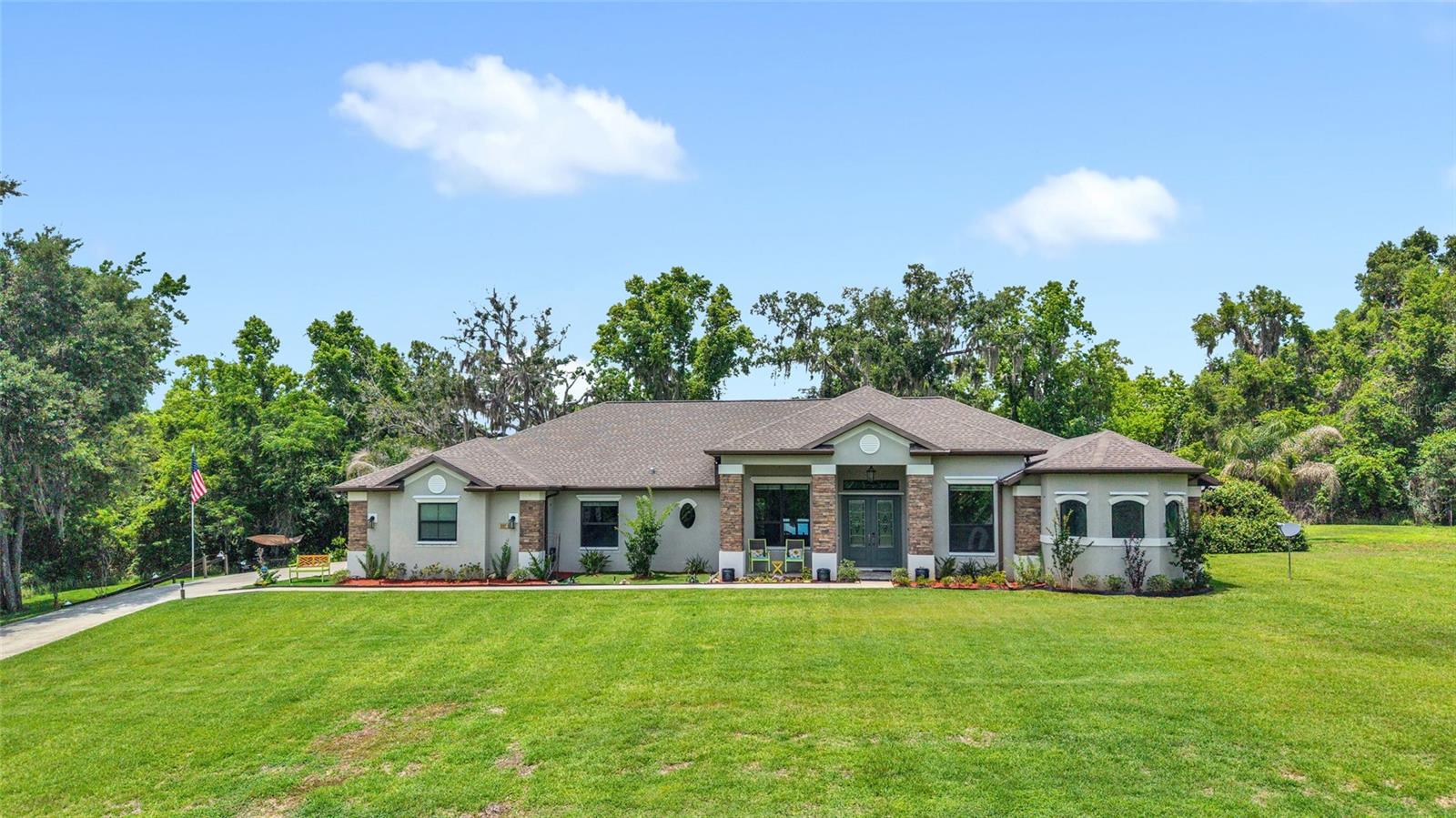 Experience elevated living in this exceptional custom-built luxury residence, completed in 2019 and thoughtfully designed with comfort, elegance, and modern convenience in mind. Situated on a large private lot, this stunning 4-bedroom, 3 full bath home offers the perfect blend of upscale finishes, smart home innovation, and versatile living space. Including a private attached in-law suite with its own separate entrance, ideal for multigenerational living, guests, or potential rental income. From the moment you enter, you'll be captivated by the expansive open-concept layout, soaring tray ceilings, and impressive 8-foot solid-core doors throughout, creating a grand yet welcoming atmosphere. The home is loaded with premium upgrades and intelligent features, including phone-controlled lighting, WiFi-enabled 3-car garage doors, a fully integrated smart home system, and a state-of-the-art 4K Bose surround sound system that delivers an immersive entertainment experience. Designed for both luxury and peace of mind, this home also includes hurricane shutters, a whole-house pest management system, security cameras surrounding the property, and a remote-start whole-house generator for added security and convenience year-round. Step outside to your own private backyard retreat where indoor and outdoor living seamlessly come together. The oversized screened lanai provides the perfect space for relaxing or entertaining, complete with a hot tub, outdoor wet bar, charming gazebo, and beautifully maintained garden areas, all overlooking the expansive private yard with plenty of room to enjoy. Every detail of this remarkable property has been carefully curated to provide a lifestyle of comfort, sophistication, and functionality. This is more than just a home, it's a private luxury sanctuary built for modern living.