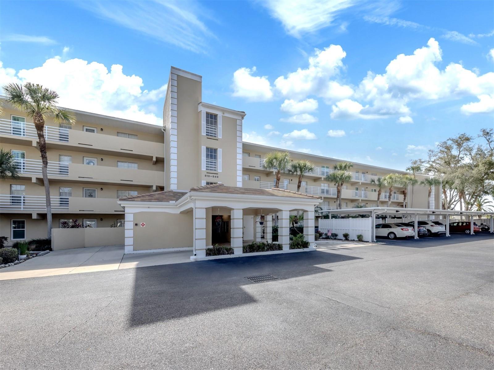 Come see this beautiful first floor coastal style condo.  RECENT PRICE IMPROVEMENT! If your priorities include convenience, comfort, safety, and affordability; you are home.  This stunning FIRST FLOOR condo is steps from your covered parking.  No need to drag your groceries into a stuffy elevator or use stairs.  As a bonus, a one year Home Tech Warranty is provided to the lucky buyers.  Enjoy expansive golf course views of the 9th tee of the Bobcat Course from your enclosed lanai or outside on your private landscaped patio.  Mature landscaping, trees and a lake create a peaceful environment for your relaxation.  
This sturdy block constructed building has a 2022 roof, fresh paint, full sprinkler protection and has been replumbed.  Located in a desirable flood zone “X-500”. This is a non-smoking building.
This 2 bedroom, 2 bathroom home with coastal style décor lives big.  Enjoy golf course views from the expansive kitchen, defined dining area, living room, enclosed lanai and owner’s suite. Great natural light provides a delightful environment.  Crown molding adds a touch of elegance.  The indoor laundry adds convenience.  Most furnutre can be available under separate agreement.  Move right in!
Enjoy the community heated pool, showers, clubhouse, library, BBQ and picnic areas.  Membership to the Plantation Golf & CC is an available option for an additional fee.    The affordable quarterly association fees provide for strong reserves for building, roads, roof, elevators, carports and already include the master assoc. fees, water and sewer.  Enjoy the convenience of living minutes to shopping, I75, restaurants and beaches.  Come see this dream come true today.