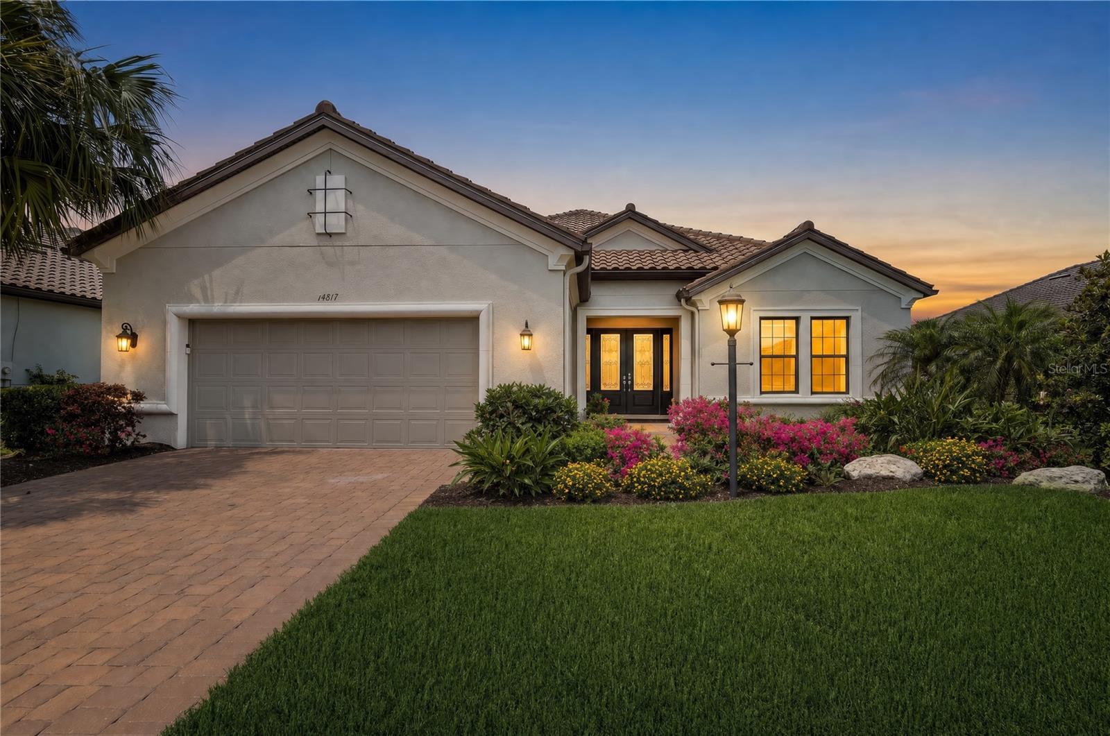 Enjoy breathtaking golf course and water views from this fully loaded 3 Bedroom, 3 Bath + Den Pallazio floor plan in the highly coveted Esplanade at Azario. Complete with a DEEDED GOLF MEMBERSHIP and showcasing an exceptional level of upgrades and designer finishes, this home truly offers the ultimate Florida luxury lifestyle. The spectacular outdoor living space is designed for both relaxation and entertaining, featuring a 31.5-foot gas-heated pool and spa, an oversized extended covered lanai, panoramic screen enclosure for unobstructed golf course and water views, two sets of pocket sliding glass doors for seamless indoor/outdoor living, a fully equipped outdoor kitchen, and elegant Shellstone pavers.  Inside, the gourmet kitchen is beautifully appointed with GE Profile stainless steel appliances, a GE Monogram wine refrigerator, gas cooktop, designer range hood, 42-inch upper cabinets, soft-close dovetail cabinetry, under-cabinet lighting, glass tile backsplash, and an oversized island perfect for gathering.  Additional upgrades throughout the home include designer lighting, quartz countertops, custom two-toned California Closets in the primary suite, garage, and storage systems, Lutron automated interior shades, 8-foot interior doors, tray ceilings, crown molding, and a luxurious primary bath with an oversized walk-in shower and rain shower head.  Additional features include a tankless gas water heater, tandem garage with abundant custom storage, and Nautilus pull-down hurricane shutters on all windows, with hurricane impact glass at the front of the home.
Come experience resort-style living at its finest in Esplanade at Azario.