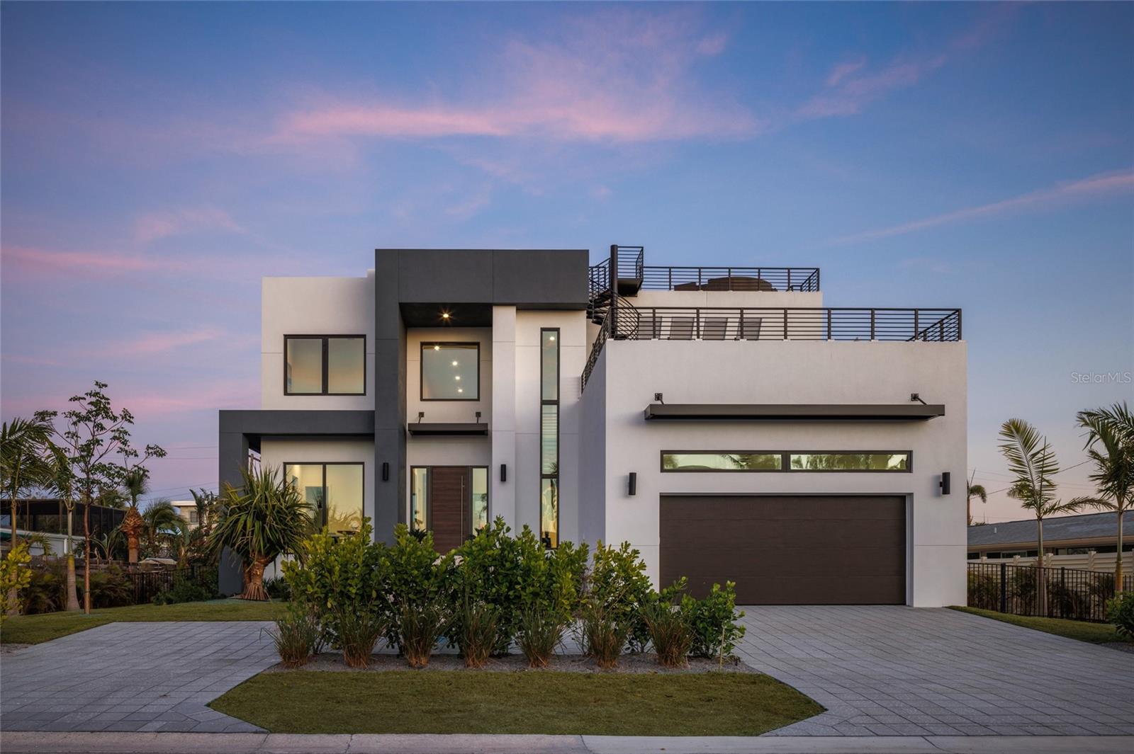 Move-in ready new construction in Lido Shores just steps from the private neighborhood beach. Skip the two-year building process and move straight into a brand new residence designed for effortless coastal living.

Clean architectural lines, walls of glass, and an open yet thoughtfully scaled floor plan create a home that feels both modern and comfortable. The main living spaces flow seamlessly to the spa, pool and outdoor entertaining areas, creating a natural connection between indoor and outdoor living.

At the center of the home, the kitchen is designed as both a showpiece and gathering space, featuring Thermador appliances, custom Italian cabinetry, and an oversized island ideal for entertaining. Generous living and dining areas allow the home to host comfortably without sacrificing privacy or everyday livability.

Each of the five bedrooms offers its own en-suite bath, creating private retreats for family and guests alike. The primary suite is designed as a true sanctuary, featuring spa-inspired finishes and a calm connection to the surrounding outdoor spaces.

One of the home’s most special features is the expansive rooftop terrace, offering sunset views toward the Gulf and a unique setting for evening entertaining or quiet moments above the neighborhood canopy.

Built by Seaward Homes and completed in 2024, the residence also includes smart home integration, custom closets and thoughtfully curated finishes throughout.

Located in Lido Shores, one of Sarasota’s most sought-after coastal neighborhoods, residents enjoy private beach access along with convenient proximity to St. Armands Circle, downtown Sarasota, and the city’s renowned dining and cultural destinations.

Recently completed and ready for immediate occupancy, this home presents a rare opportunity to enjoy brand new construction in Lido Shores without the time, complexity, and rising costs of building.