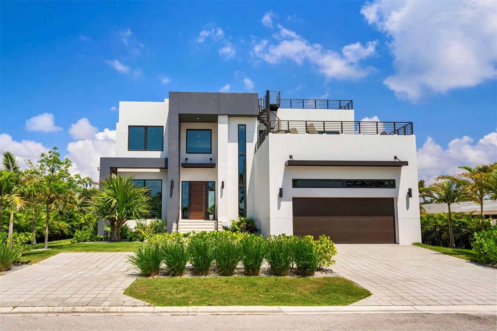 In a market where building a custom home can take years, this recently completed residence offers something increasingly rare: the opportunity to move immediately into a new home in one of Sarasota's most coveted beachside neighborhoods.
Located just moments from the private Lido Shores beach access, the home was thoughtfully designed for modern coastal living, blending clean architectural lines, expansive walls of glass, and seamless indoor-outdoor spaces. Every detail has already been completed, allowing the next owner to enjoy the benefits of new construction without the uncertainty, delays, and escalating costs associated with building today.
The heart of the home is a beautifully appointed kitchen featuring Thermador appliances, custom Italian cabinetry, and an oversized island that naturally serves as the gathering place for family and guests. Open-concept living and dining spaces connect effortlessly to the pool, spa, and outdoor entertaining areas, creating a home equally suited for everyday living and large-scale entertaining.
All five bedrooms feature en-suite baths, providing privacy and comfort for both owners and guests. The primary suite serves as a private retreat, complete with spa-inspired finishes and a tranquil connection to the surrounding outdoor spaces.
Above it all, an expansive rooftop terrace captures spectacular sunset views toward the Gulf of Mexico—a rare feature that provides an additional layer of outdoor living and entertaining space seldom found in the neighborhood.
Completed in 2024 by Seaward Homes, the residence is equipped with smart-home technology, custom closets, premium finishes, and the level of quality expected in a newly built luxury home.
Lido Shores remains one of Sarasota's most sought-after waterfront communities, offering private beach access and an unmatched location between St. Armands Circle, Downtown Sarasota and Longboat Key. Residents enjoy convenient access to award-winning restaurants, cultural attractions, marinas, and some of the region's finest waterfront amenities.
For buyers seeking new construction in Lido Shores, opportunities are exceptionally limited. This is a chance to enjoy the benefits of a brand-new residence today rather than waiting years for one to be built.