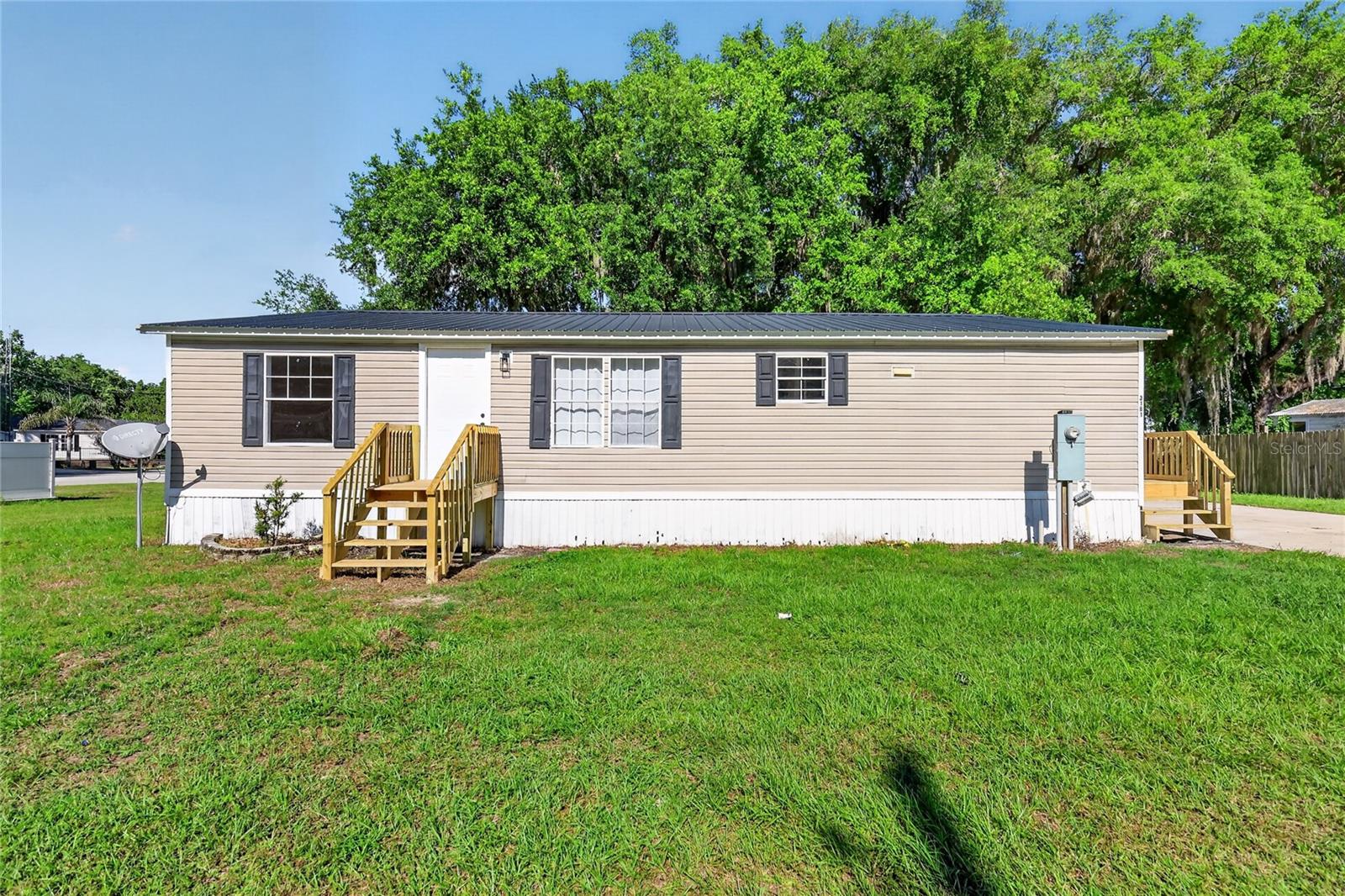 Welcome to 3181 County Road 521B! This stunning 1,152 sq ft manufactured home has been completely transformed with high-end finishes throughout. Situated on a peaceful 0.164-acre lot in Coleman Oaks, this 2006 home is truly move-in ready.

The brand new kitchen features elegant shaker cabinets, quartz countertops with island bar, and a complete stainless steel appliance package (range, microwave hood, dishwasher, refrigerator). Washer and dryer also convey – all with 1-year warranty. Brand new LVP flooring and recessed lighting throughout create a modern feel.

The master suite offers a walk-in closet, built-in closet, and luxurious ensuite bath with his and hers vanities, quartz countertops, garden tub, and separate stand-up shower. The guest bathroom features a 54" vanity with matching quartz and tub/shower combo. Enjoy your screened-in rear deck perfect for relaxing, and rest easy with a 7-year-old metal roof and 6-year-old HVAC system with updated heat pump. Community well and septic maintained by HOA.

Prime Location! Just minutes from The Villages, Florida's premier community with world-class golf courses, recreation centers, shopping, and dining. Easy access to Lake Deaton for boating and fishing, nearby parks, grocery stores, and medical facilities. Conveniently located near US-301 and Florida's Turnpike for easy commuting to Orlando, Ocala, and Tampa.

This completely renovated home combines modern luxury with practical living in a quiet community. Don't miss this turnkey opportunity – schedule your showing today!