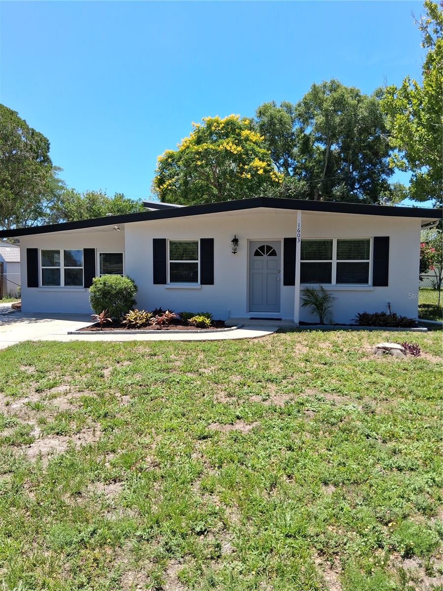Must see this block mid century modern home that was just completely updated. Nothing to do but move in and enjoy.  True 3 bedroom, 1 and a half baths, living room, eat in kitchen and seperate family room with half bath. Great sized fenced in back yard with large storage shed. Nice screened in patio with washer and dryer hookups overlooking the yard. Complete new kitchen with lots of shaker cabinets, granite counters and stainless appliances. Both baths updated with new vanities, main bath new tub and tile surround. Brand new Rheem ac system and hot water tank in 2026. Roof was installed 2021. Other new includes: paint in and out, luxury vinyl flooring throughout, also all lighting and 5 fans. Property in flood zone X and no HOA. Very convenient Clearwater location with wide streets and friendly neighbors. Hurry to see this one as the good ones go fast!