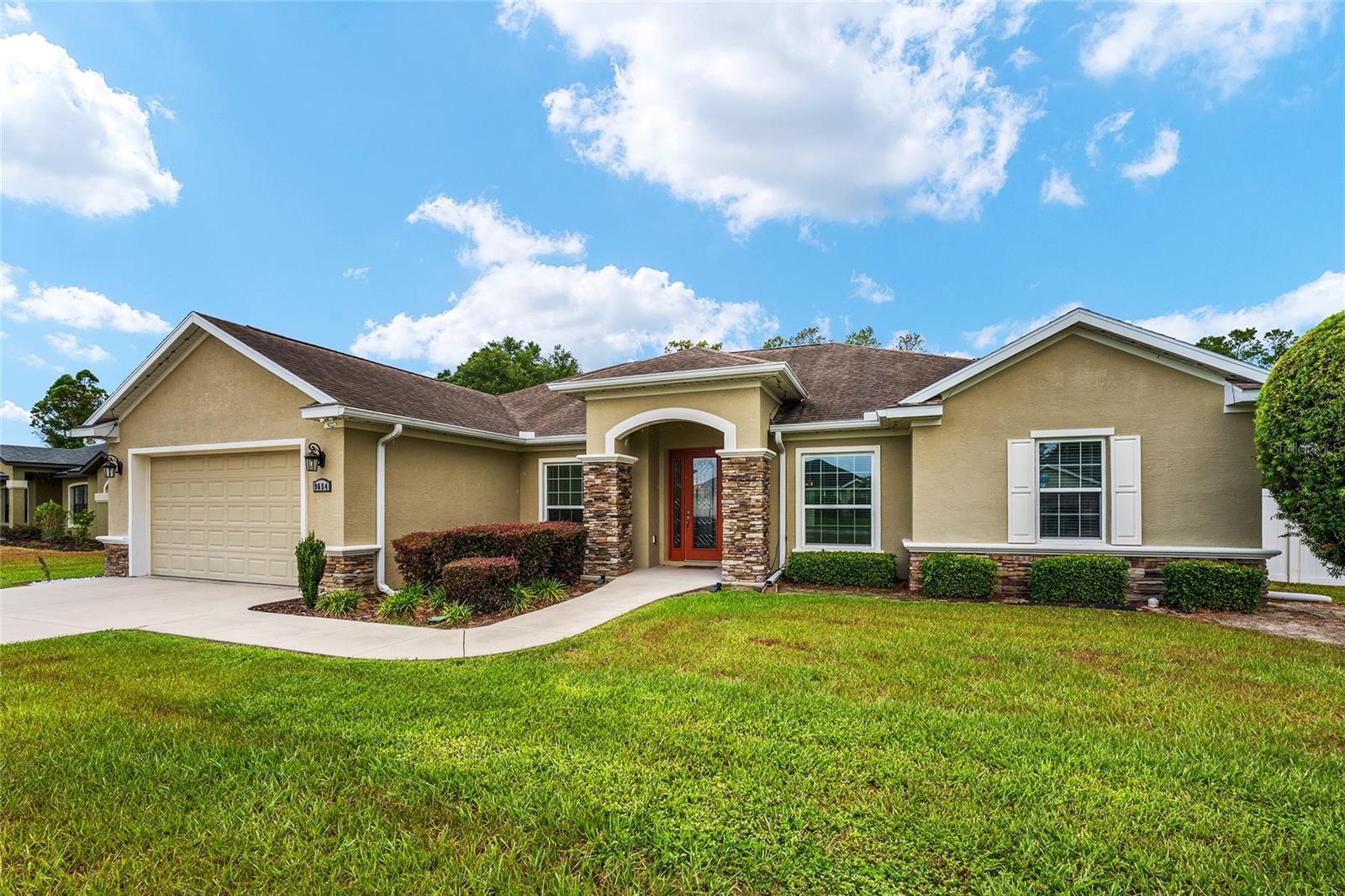 Welcome to this beautifully maintained Triple Crown custom home offering 4 bedrooms, 3 full bathrooms, a separate private office and 2,397 square feet of bright, open living space on a fully fenced 0.48-acre lot. Fresh interior paint, large windows, high ceilings, 8-foot doors, tall baseboards, crown molding and wood-look ceramic tile give the home a polished, custom feel throughout the main living areas.

The spacious family room is highlighted by an impressive coffered ceiling and triple sliding glass doors that open to the oversized screened and covered lanai, creating an easy connection between indoor and outdoor living. The kitchen overlooks the main living area and features granite countertops, a large center island, abundant cabinetry, stainless steel appliances and an eat-in dining area. A separate formal dining room and private office with a glass door provide added flexibility for work, study or additional living space.

The desirable triple-split bedroom plan offers excellent privacy. Two secondary bedrooms share a full bathroom, while the separate fourth bedroom is located near another full bath, making it ideal for guests, multigenerational living or a private suite. The spacious primary suite includes two walk-in closets and a spa-inspired bathroom with dual vanities and an oversized glass-enclosed shower with multiple showerheads.

Outside, enjoy the large screened lanai, hot tub, firepit area and expansive fenced backyard. Bring your chickens—there is no HOA, and chickens are permitted subject to applicable county regulations. The property also includes a substantial storage shed with electricity and a window air-conditioning unit, providing useful space for storage, hobbies or a workshop.

Additional features include a two-car garage, inside laundry room with utility sink, energy-efficient windows and numerous custom details throughout. Located in a welcoming southwest Ocala neighborhood near Publix at Cherrywood, Freedom Public Library and the Heath Brook shopping area, with convenient access to Marshalls, DICK’S Sporting Goods, Barnes & Noble, Dillard’s, restaurants and everyday services.