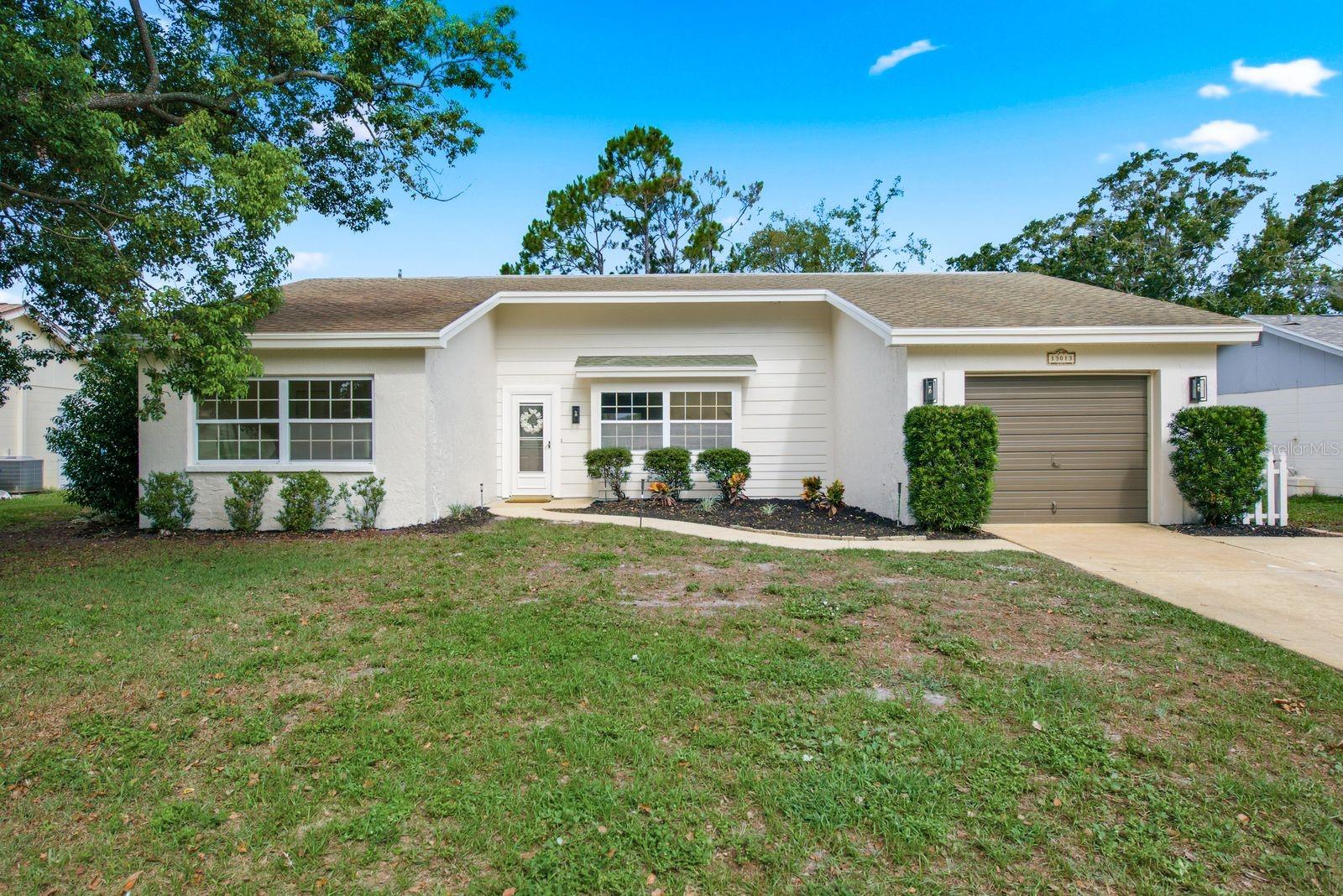 Welcome to 13013 Spicebox Way, a beautifully updated, move in ready home in the amenity filled Beacon Woods East community! Fresh and modern throughout, this home features updated bathrooms, luxury vinyl plank flooring, fresh interior paint, and an updated kitchen with stainless steel appliances and a convenient pass through to the expansive screened lanai.

The bright, open living and dining areas provide plenty of space to relax and entertain, while the generously sized bedrooms and stylishly updated bathrooms add to the home's comfortable, modern feel. Step outside to the large screened and covered lanai overlooking a spacious backyard, an ideal setting for morning coffee, weekend gatherings, or simply enjoying the Florida lifestyle. An attached one car garage provides additional storage and everyday convenience.

Living in Beacon Woods East means there is plenty to enjoy beyond your front door. Spend sunny afternoons at the community pool, hit the tennis courts, enjoy the clubhouse, or take part in the many community activities and social events offered throughout the year. With beautiful updates inside, great outdoor living space, and a community packed with amenities, 13013 Spicebox Way is ready to welcome you home!