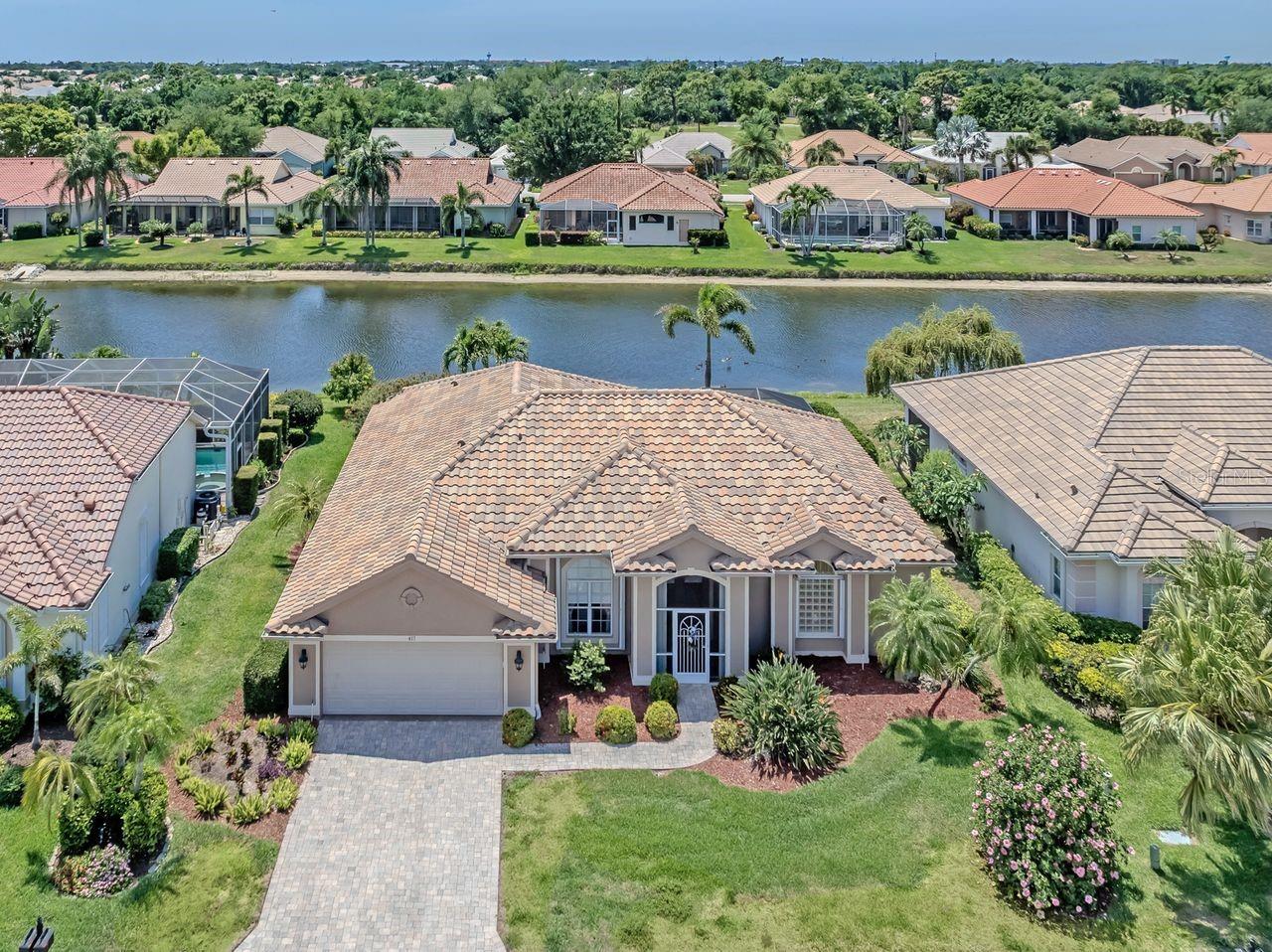 Nestled within Premier Pelican Pointe Golf & Country Club, this beautifully maintained 3-bedroom, 2 bath home with 2 car garage showcases sparkling lake views. For peace of mind, it offers a NEWER ROOF & ACCORDIAN SHUTTERS for the entire home. Designed with comfort & entertaining in mind, the home features desirable split plan, a tranquil primary suite retreat, and spacious living areas including a relaxing family room, dining area and inviting living room. Highlights of the updated kitchen are granite countertops, breakfast bar, stylish backsplash, newer appliances and a convenient built-in desk area. Enjoy seamless indoor-outdoor living with a dual lanai, covered plus extended screen lanai overlooking the serene lake-perfect for entertaining or simply relaxing in the sunshine. The versatile 3rd bedroom is complete with a space saving Murphy bed. 
The award-winning Pelican Pointe Golf & CC has resort style amenities including 27 holes of semi-private golf, heated community pool, fitness center, tennis & pickleball courts, and a full-service restaurant and pub. Golf membership is optional & not required. Low HOA fee includes lawn care, high speed internet, Cable TV, 24-hour gated security, and social membership, making this the perfect opportunity to enjoy the ultimate Venice lifestyle.