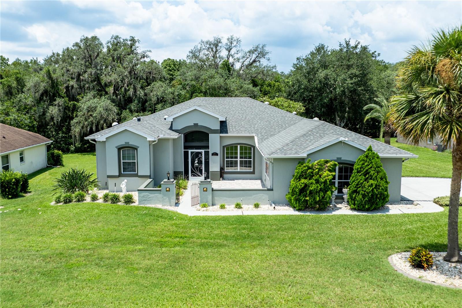 This Home has it All! Do not wait to visit 5121 Aurora Circle. This beautifully maintained Scarborough model has been thoughtfully updated and is move-in ready, with a new roof (2025) and a new A/C system (2022) — major-ticket items already taken care of for the next owner. Tucked on a desirable corner/cul-de-sac lot, the home offers a side-entry, oversized 3-car garage with overhead attic storage, giving it wonderful curb appeal and easy in-and-out access. Beyond the cul-de-sac setting, there are no rear neighbors — just a peaceful conservation view of the St. John's Conservation area right out back, with the community river park and walking trail just steps away for added privacy and a true sense of retreat.Step inside through leaded glass double French doors into a living room with soaring vaulted ceilings, setting the tone for the open, split floor plan that flows throughout. Six solar tubes bring in an abundance of natural light, and three sets of double French doors — including one leading from the primary bedroom — connect the interior seamlessly to the extended, screened paver lanai. Out there, you'll find a swim-current pool and spa/hot tub overlooking the conservation area, plus two ceiling fans on the lanai and one in the garage for year-round comfort. Decorative ceiling fans are also featured in all three bedrooms and the family room.The kitchen is both stylish and functional, with 42" solid wood cabinets, double pull-out drawers for pots and pans, additional pull-outs in the pantry, a built-in desk, a breakfast counter, and ceramic tile flooring. The spacious primary bedroom offers direct lanai access along with two walk-in closets featuring custom-built drawers and shelving. The en-suite primary bath is a true retreat, complete with a jetted garden tub, separate ceramic-tiled walk-in shower, Corian double-sink counters, ceramic tile flooring, and a private water closet.Additional energy-efficient features include foam-filled insulated walls, a radiant roof barrier, a small natural gas heater in the primary bedroom, and double-pane windows throughout — all helping keep utility costs down. A whole-house central vacuum system adds everyday convenience.Located in the sought-after Legacy of Leesburg community, residents enjoy access to tennis, bocce ball, and pickleball courts, a resort-style pool, a state-of-the-art fitness center, a pool hall, library, activity and craft rooms, a softball field, a community hall for gatherings, multiple walking trails, and RV/boat storage. The HOA fee of just $293/month covers lawn care (cutting, edging, and debris blowing), cable, internet, RV/boat storage, and full use of all community amenities. All information recorded in the MLS is intended to be accurate however, it should be independently verified by buyer and their agent.