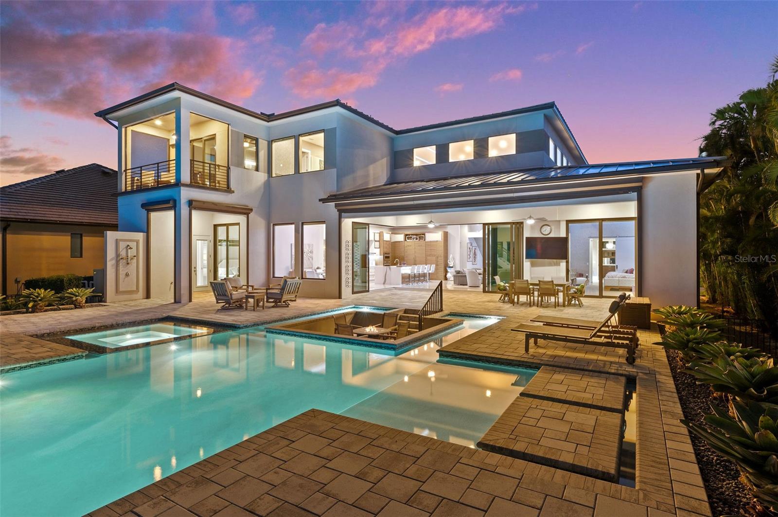 Luxury meets waterfront living in this 2-story contemporary masterpiece located in Cape Coral's coveted Yacht Club area. With almost 5000 sq ft of interior living space, this 5 bedrooms, 7 bathrooms, and a 3-car garage home offers unparalleled elegance and panoramic views of the Caloosahatchee River.  

Key features include a gourmet kitchen with an induction cooktop, a cappuccino maker, and a temperature-controlled wine room. The resort-style pool overlooks the river, providing the perfect setting for outdoor living.

Boasting unique wall coverings, fixtures, and furnishings throughout, this fully furnished home is move-in ready. Enjoy sunrises and sunsets from the glass-walled great room or the outdoor seating area with a fire pit.

Boating enthusiasts will appreciate the 20,000 lb covered boat lift, providing quick access to world-renowned beaches. With two master suites on the second level, a loft, and a workout area with a private balcony, this home is designed for luxurious living.

Centrally located near restaurants, this property seamlessly combines luxury and convenience. Don't miss the chance to experience the epitome of Cape Coral's riverside lifestyle.