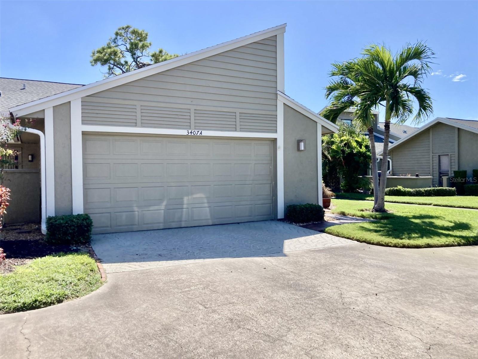 This three bedroom - two bath villa is located on the 4th fairway at the IMG Country Club.  It is very spacious with an open floor plan.  The kitchen has been remodeled with new cabinets, Corian countertops and stainless steel appliances.  It also includes extra cabinets, including a wine cooler and a breakfast bar that seats two.  There are sliding glass doors to a screened porch with tile floors and leads to an outside deck - perfect for sunning and grilling.  The living room is completed with sliding doors to the deck and features a fireplace.  Off the formal dining room is a pretty landscaped atrium.  The master bedroom has sliding doors to a patio area and has it's own bathroom which has a walk-in shower, tub and dual sinks.  There is a walk-in closet plus another closet.  There are vaulted ceilings in the living room, dining room, kitchen and master bedroom. Seller is offering a $5000 carpet allowance.  Across the street from the villa is the heated pool. The villa is in the IMG Country Club area which has an 18 hole regulation golf course and a beautiful clubhouse with grill room and dining room overlooking Sarasota Bay.  The course is semi-private, open to the public along with the clubhouse.  On El Conquistador parkway is also a tennis club.  It is approximately 8 miles to the beach.  The community is close to IMG Academy, State College of Florida and other schools.  Shopping is close by and Sarasota is about 15 minutes away.  It is a perfect location!