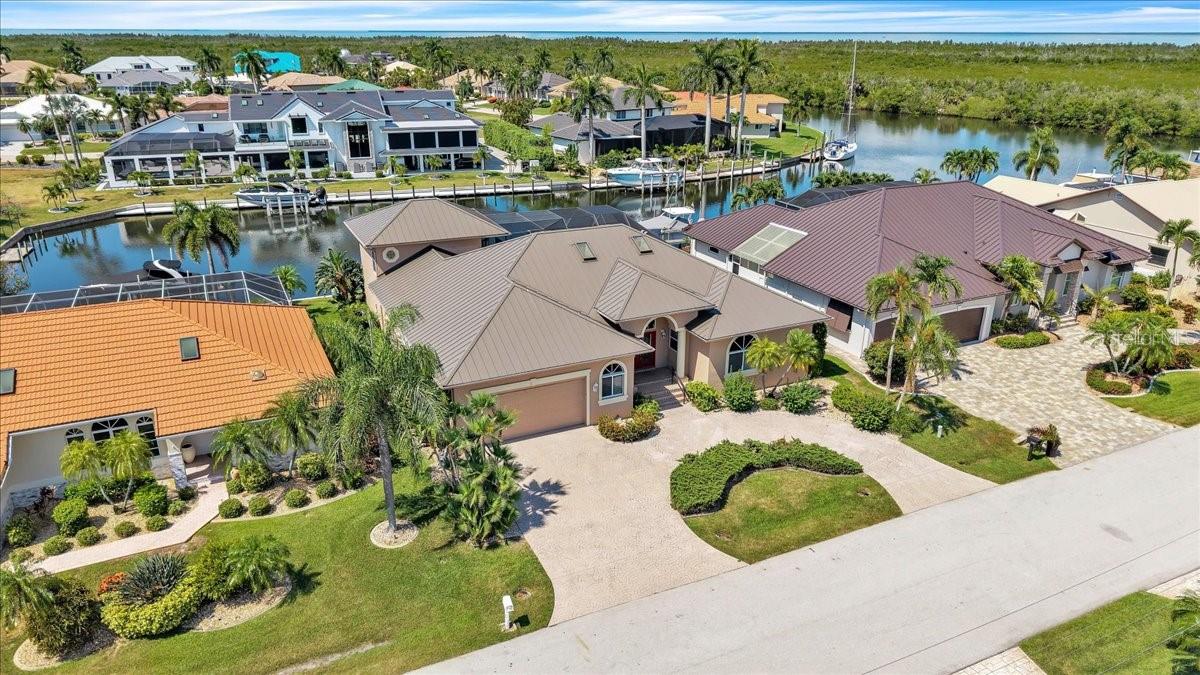 Perfectly positioned on an 80-foot stretch of deep-water, sailboat-access canal with no bridges to Charlotte Harbor, this impressive 4-bedroom, 3-bath residence offers more than 3,000 square feet of living space in one of Punta Gorda Isles' premier boating locations. Just minutes from the harbor, you'll enjoy effortless access to world-class fishing, sailing, and the Gulf waters beyond.

Designed with generous proportions and a timeless floor plan, the home features expansive living areas, spacious bedrooms, and an inviting layout ideal for entertaining or everyday living. One of the bedrooms is upstairs with its own ensuite and private balcony overlooking the heated pool and spa, with sweeping views of the picturesque perimeter canal leading directly to the harbor, all while protected by the 2-story lanai cage.  Imagine total privacy for guests, hobby room, or an art studio!  

Outside, the screened lanai, heated pool, and spa create a private waterfront retreat where you'll enjoy the best of Florida's indoor-outdoor lifestyle. With 80 feet of seawall and deep-water sailboat access, and a 10,000lb boat lift, this property is perfectly suited for serious boaters.

While the home is ready for a fresh vision and modern updates, its exceptional location, expansive floor plan, and premier waterfront setting create the perfect canvas for a spectacular custom renovation. Major improvements, including new plumbing, a newer A/C system, and a durable metal roof, provide a solid foundation for your transformation. Opportunities to own more than 3,000 square feet on sailboat-access water, just minutes from Charlotte Harbor, are becoming increasingly rare, making this an exceptional opportunity to create your dream waterfront retreat.
Bring your imagination and transform this exceptional property into the waterfront masterpiece you've always envisioned.