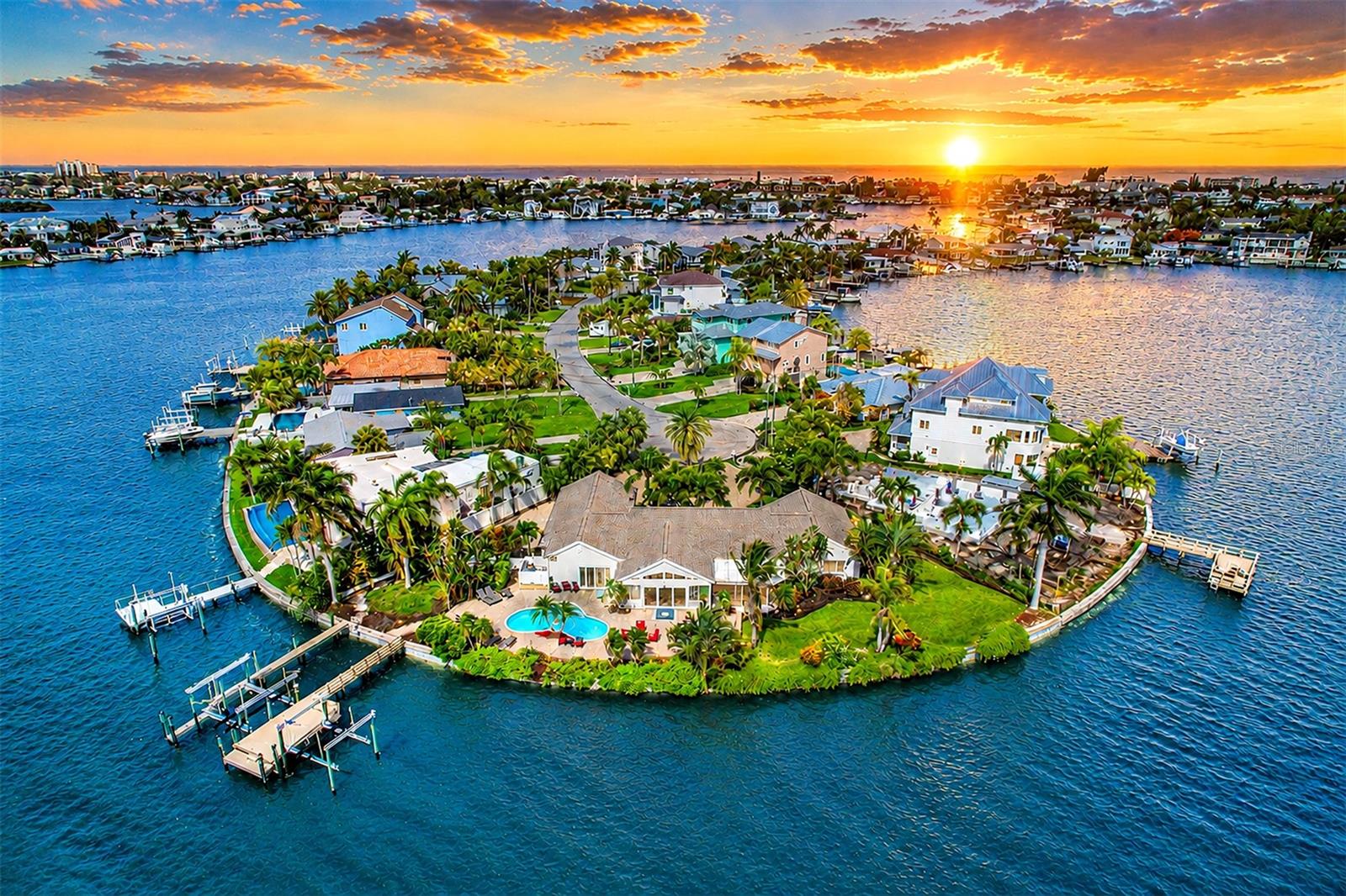 Rare waterfront retreat in the heart of Indian Rocks Beach. This extraordinary waterfront estate offers a level of privacy, serenity and coastal beauty that is rare. THIS HOME TOOK ON ZERO WATER INTRUSION. Set on an expansive "DOUBLE LOT" with 216 feet of water frontage, the property feels like a private resort, surrounded by lush tropical landscaping featuring mature palms that create a secluded paradise. Enjoy panoramic views, dolphins play just beyond the dock and relax beside the pool. Professional landscape lighting transforms the property into a magical waterfront oasis, creating the ideal backdrop for an evening swim, cocktails around the fire table or dining under the stars. The outdoor pool, shower and bath work well to avoid unnecessary wet entry to the main house. Boaters/anglers alike will appreciate the waterfront amenities, a large dock installed 2021, with water service, electrical hookups, a 24,000-pound and 10,000-pound boat lift. Whether heading out for a day on the water or casting a line from your backyard, this property is designed to embrace the waterfront lifestyle. Multiple outdoor gathering spaces offer something for everyone. The covered patio provides a comfortable retreat for grilling, entertaining, or watching the game, while the expansive lawn offers endless possibilities:  a future putting green or additional outdoor enhancements. A tucked away section of the property presents an opportunity for a hot tub, tiki hut or additional private retreat. The fenced yard provides a space for pets. Inside, the thoughtful design accommodates everyday living and entertainment. This property is fully furnished and decorated, making it turnkey ready for instant rentals or staying the night yourself. Primary suite enjoys direct pool access and captures beautiful sunrise views. Split-bedroom floor plan offers privacy. One guest bedroom features stunning Intracoastal views, while the flexible fourth bedroom can easily serve as a home office or den. The spacious living areas comfortably accommodate large gatherings, with a generous dining room, an inviting sunroom ideal for morning coffee and a separate family room that opens directly to the covered patio. The well-appointed kitchen offers abundant cabinetry and workspace, with excellent potential for a future open-concept redesign. A large laundry room provides additional storage and flexibility for future customization. Designed for effortless indoor-outdoor living, this home has hosted everything from family reunions to weddings and offers a floor plan that seamlessly blends comfort, functionality and entertaining space. On a quiet cul-de-sac with friendly neighbors and a mix of full-time and seasonal residents, the setting is peaceful while remaining incredibly convenient. Enjoy a short golf cart ride to the beach, local restaurants, parks and the beloved Indian Rocks Beach Art Center. Seeking an investment opportunity, the property has a proven history as a successful short-term rental. Its unique combination of privacy, waterfront amenities and prime location has made it a favorite among guests, creating an exceptional experience for visitors while maintaining harmony with the surrounding neighborhood. Searching for a primary residence, vacation retreat or potential income-producing waterfront property, this remarkable coastal estate offers a lifestyle that must be experienced to be fully appreciated. Additionally, It has the potential to rebuild or split into two lots