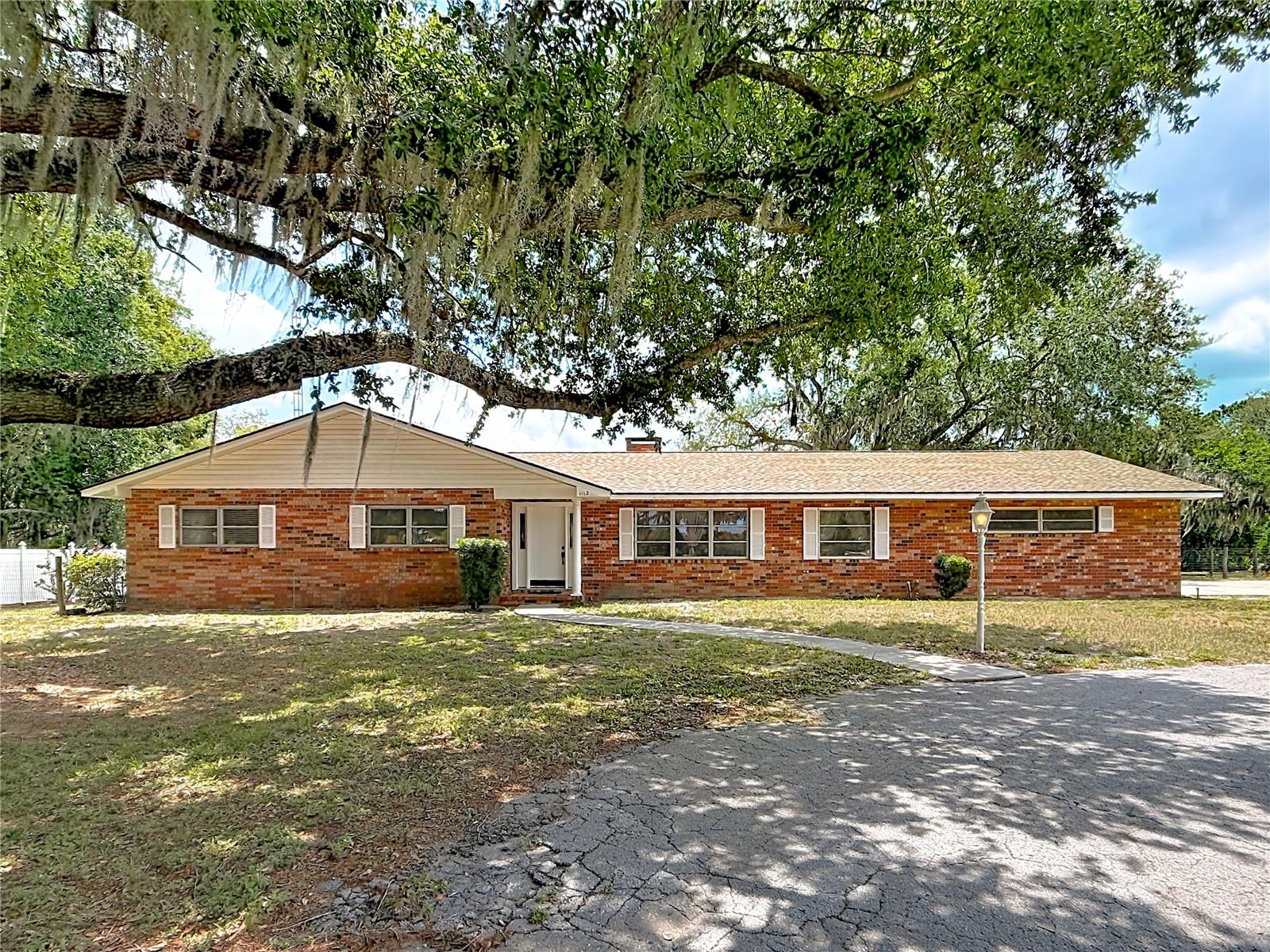 Rare Find in a Fantastic Location! Conveniently located near schools, shopping, restaurants, and charming downtown Leesburg, with easy access to the renowned Harris Chain of Lakes, famous for boating, fishing, and waterfront recreation. Just minutes from The Villages, offering endless dining, shopping, entertainment, and employment opportunities. Quick access to both I-75 and Florida's Turnpike makes commuting a breeze.

This well-maintained home offers just under 1,800 square feet of living space with 3 bedrooms and 3 full baths. Inside you'll find a wood-burning fireplace, built-ins, French doors, ceiling fans throughout, a formal living room, dining room, and a spacious family room featuring beautiful pecky cypress accent walls. The kitchen includes stainless steel appliances, a breakfast bar, and a large closet pantry.

Major updates include a 2021 HVAC system, new submersible well pump, new iron tank, newer pool pump and filter, and a pool light currently being replaced. The home is also equipped with a water softener, chlorinator, and dechlorinator system.

The oversized 16' x 6' utility/laundry room offers abundant cabinet storage and includes the third full bath. Step outside to the impressive 28' x 12' screened porch, perfect for entertaining, family gatherings, or simply enjoying the peaceful country setting.

Cool off in the sparkling in-ground pool with an 8-foot deep end, surrounded by a decorative concrete pool deck. The partially fenced yard is ideal for pets and includes a large detached shed plus a covered carport area perfect for storing your boat, tractor, or additional equipment.

Bring your boats, RVs, and all your toys! With plenty of room to expand, there's ample space to build a pole barn, detached garage, workshop, or even a second home/in-law suite (buyer to verify zoning and county requirements). So much to offer at an incredible price—don't miss this opportunity!