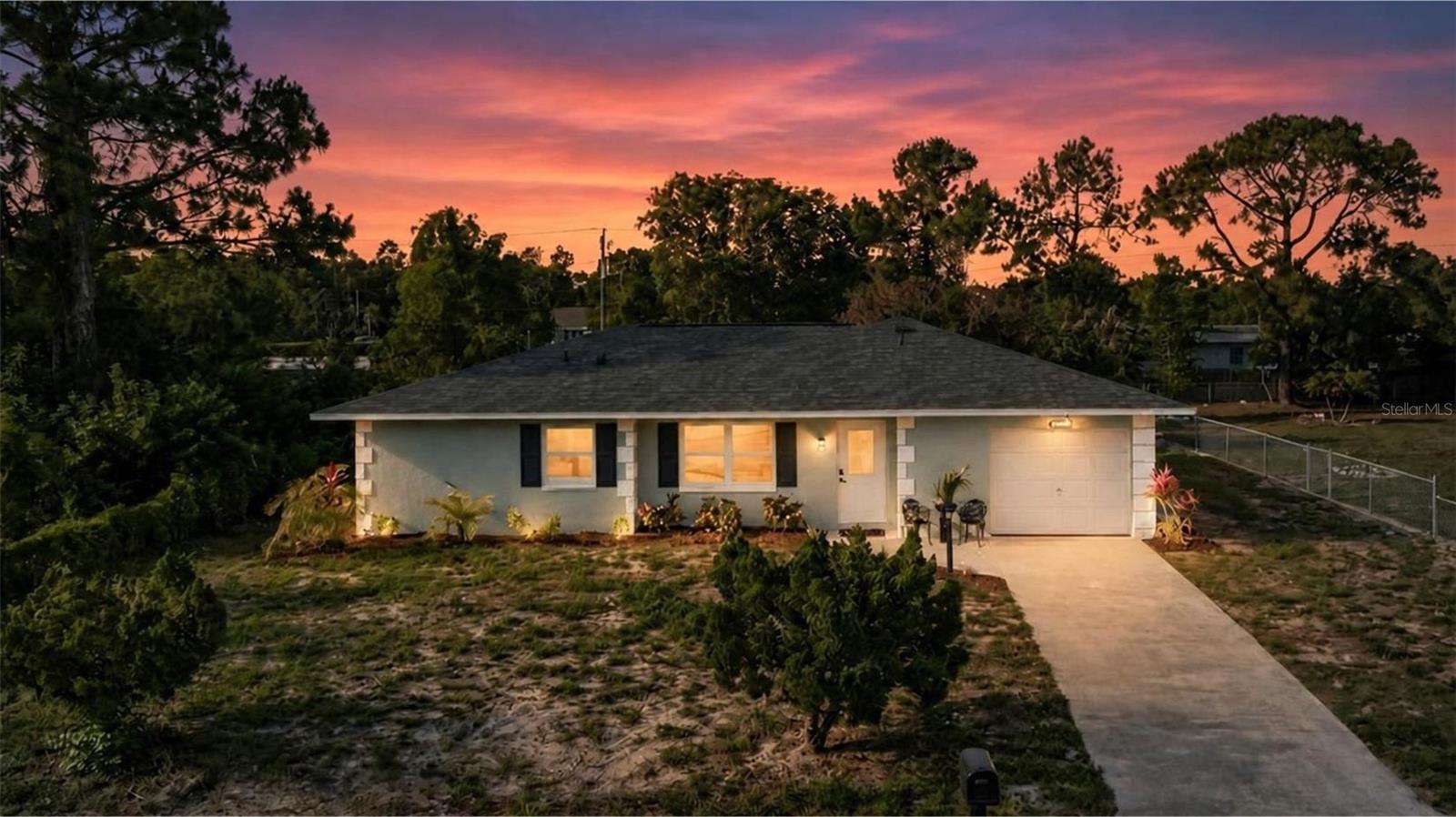 Welcome to this completely renovated 3-bedroom, 2-bathroom 1496 sqft Lehigh Acres retreat where every inch has been thoughtfully redone. Step inside to a sun-soaked open-concept floor plan with brand-new luxury vinyl flooring, fresh paint, recessed LED lighting on dimmers, and modern matte fixtures throughout.

The chef's kitchen stuns with shaker cabinets, quartz countertops, a sleek glass backsplash, floating wood shelves, and a brand-new stainless appliance package. Both bathrooms have been fully redone — the primary ensuite features a floor-to-ceiling luxury tile walk-in shower with sliding glass door ; the guest bath offers a luxury-tiled soaking tub. The spacious primary bedroom plus two additional bedrooms give you room to grow.

Outside, your massive screened lanai overlooks a fenced 10,880 SF backyard with mature mango trees and a stone firepit w/ plenty of space for various activities. NEW roof, NEW water heater, NEW windows, NEW landscaping. Attached 1-car garage, central A/C, well & septic.

Walkable to local amenities and minutes to downtown Fort Myers. True turnkey — just bring your suitcase. Schedule your private tour today.

NOTE : Black shutters to be added on both sides of the 2 front windows