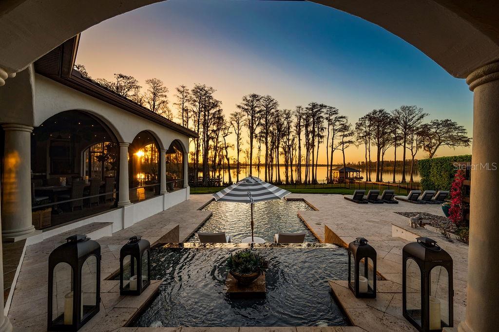 One of a kind extraordinary lakefront estate, perfectly positioned along the shores of Lake Tibet Butler on the renowned Butler Chain of Lakes,  offers over 7,600 square feet of refined living in the beautiful guard-gated community of Keene’s Pointe. Tucked at the end of a quiet cul-de-sac on coveted Greatwater Drive, the residence enjoys one of the most picturesque  settings in the community, where timeless architecture, exceptional craftsmanship, and breathtaking water views create a truly remarkable Florida lifestyle.

A brick-paver circular drive and stately entry introduce interiors where thoughtful design and luxurious finishes are evident throughout. Expansive living spaces are framed by large windows capturing stunning lake views and filling the home with natural light.

The residence features five spacious bedrooms, each with its own private en-suite bath and custom-designed closet systems, along with two additional half baths for residents and guests. The primary suite serves as a private retreat with a natural gas fireplace, automated window shades, completely updated modernized  spa-inspired bath and dual closets.

At the heart of the home, the chef’s kitchen is designed for both everyday living and entertaining, featuring premium Wolf appliances, a concealed Sub-Zero refrigerator, warming drawer, ice maker, and extensive custom cabinetry. Adjacent living and dining spaces flow seamlessly for effortless gatherings.

Designed with entertaining in mind, the home offers two  wet bars — one in the main living area and another in the expansive game room , both completely remodeled to reflect todays best design standard's— along with a dedicated theater room for an immersive cinematic experience.

Outdoor living is equally impressive. A large screen-enclosed lanai with summer kitchen overlooks the resort-style pool and sparkling lake beyond. The infinity-edge saltwater pool with cascading waterfall and adjoining spa creates a private oasis ideal for relaxing or entertaining while enjoying panoramic water views.

Other recent upgrades and remodels include a complete new Savant Smart home system, new floors throughout, new offices 2, upstairs game room, master bedroom , bath and closets, upgraded kitchen and AC Dog run with new laundry.

The beautifully landscaped grounds extend to a private dock with two boat lifts, providing effortless access to Lake Tibet Butler and the Butler Chain of Lakes — one of Central Florida’s most sought-after recreational waterways.

Furnishings available.

Additional highlights include a four-plus car garage with a dedicated golf cart bay for added convenience.

Residents of Keene’s Pointe enjoy 24-hour guard-gated security, a private community boat ramp, playground, and the opportunity to join The Golden Bear Club, home to the Jack Nicklaus Signature golf course, clubhouse, dining, fitness, and tennis.

This exceptional lakefront estate presents a rare opportunity to experience refined waterfront living in one of Windermere’s most desirable communities.