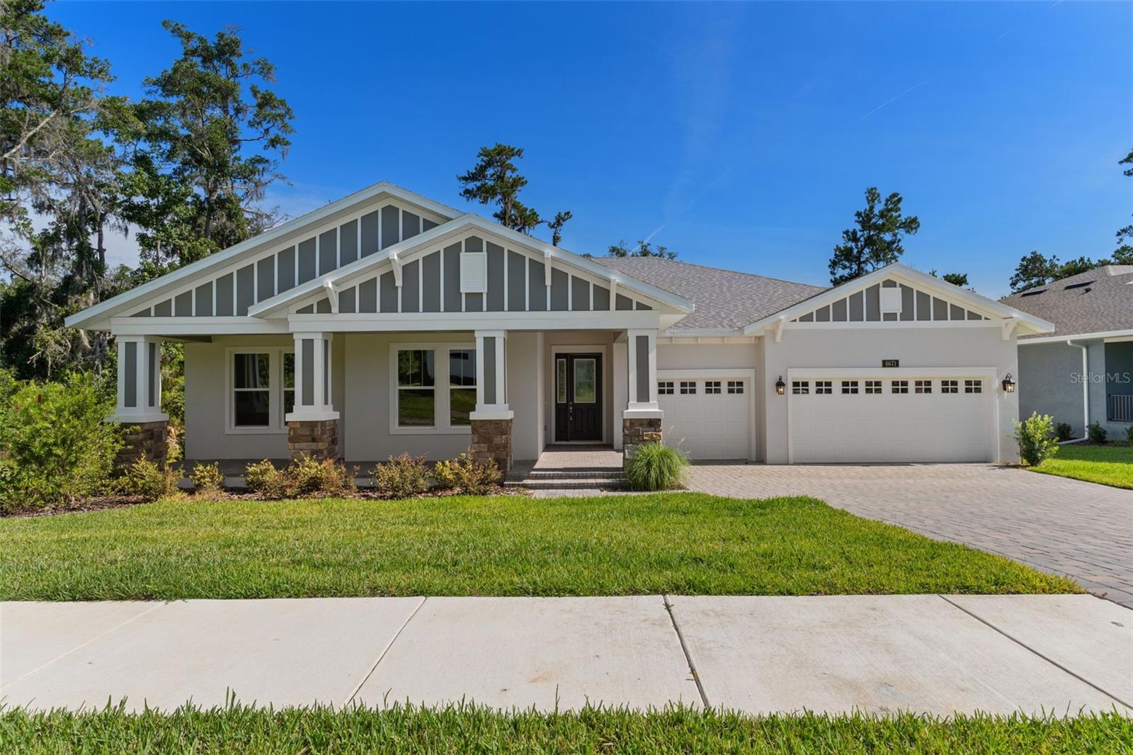 Virtually Staged. This magnificent semi-custom home was built by Spire homes in the sought-after golf course community of Southern Hills Plantation. The premier conservation homesite showcases a forever tree-lined view and no homes will be built behind it. If you are looking for total peace and privacy, then this location and home will be for you! Spire Homes' Venice floor plan features 2,667 SF of beauty and elegance, starting with a lovely foyer entry, a massive great room with tray ceiling, and a beautifully situated 12x14 den or flex room. There are three large bedrooms, three full baths, two separate lanais, and a three-car garage with storage closet. The gourmet kitchen offers beautiful cabinetry with soft close drawers, quartz countertops, subway backsplash and a spacious island with pendant lighting, double sinks and a five burner gas cooktop. The primary bedroom suite is spacious and has two walk-in closets. The primary en-suite bathroom showcases a free-standing tub, gorgeous shower and dual sinks with quartz countertops. The beauty of 8' doors, 5.25" baseboards, Lifetime Warranty LVP flooring in the main areas, dual pane Low-E windows and so much more runs throughout this amazing home! Four natural gas drops include a gas drop for a future outdoor kitchen on one of the two separate lanais, the tankless water heater, the five burner cooktop and a gas (or electric) dryer. All this and more! Southern Hills Plantation is a premier golf course and lifestyle community. It features a manned and gated entrance and showcases a Pete Dye 18-hole Signature Golf Course where golf and outdoor living merge at their finest. The stunning topography offers some of the most beautiful and serene views and vistas anywhere to be found. Amenities include Har-Tru clay tennis courts, pickleball, full-service fitness center, swimming pool with an attached tiki bar-type cafe, grand clubhouse, pro shop, driving range, putting green and both formal and informal restaurants. Don't miss this opportunity to own this fabulous home and live in a lifestyle paradise!