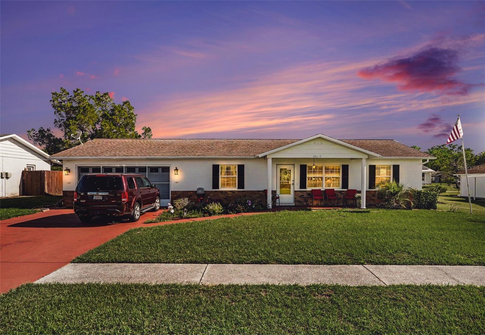 Welcome to this well-maintained 2-bedroom, 2-bathroom block home located in the desirable Alpha Village community of Zephyrhills, Florida. A covered front porch with storm door provides a welcoming entrance into the spacious living room. The split-bedroom floor plan offers privacy and convenience. The primary suite is situated on one side of the home and features a generous walk-in closet and private bathroom with a walk-in shower. The second bedroom is located on the opposite side of the home, adjacent to the guest bathroom. The galley-style kitchen includes all appliances and is complemented by a separate breakfast nook for casual dining. At the rear of the home, you'll find a dedicated dining room that offers excellent flexibility and could easily be converted into a third bedroom, home office, craft room, sewing room, or hobby space to suit your needs. The attached 2-car garage is equipped with a mini-split air conditioning system, making it a comfortable year-round space. The current owners have utilized the garage as a family room, and two Murphy beds are conveniently stored in the wall closet. The washer and dryer are also located in the garage. Go outside to enjoy the relaxing backyard, featuring an open patio, designated grilling area, and a storage shed for added convenience. This move-in-ready home offers comfort, versatility, and value. Schedule your private showing today—homes like this don't stay on the market for long!