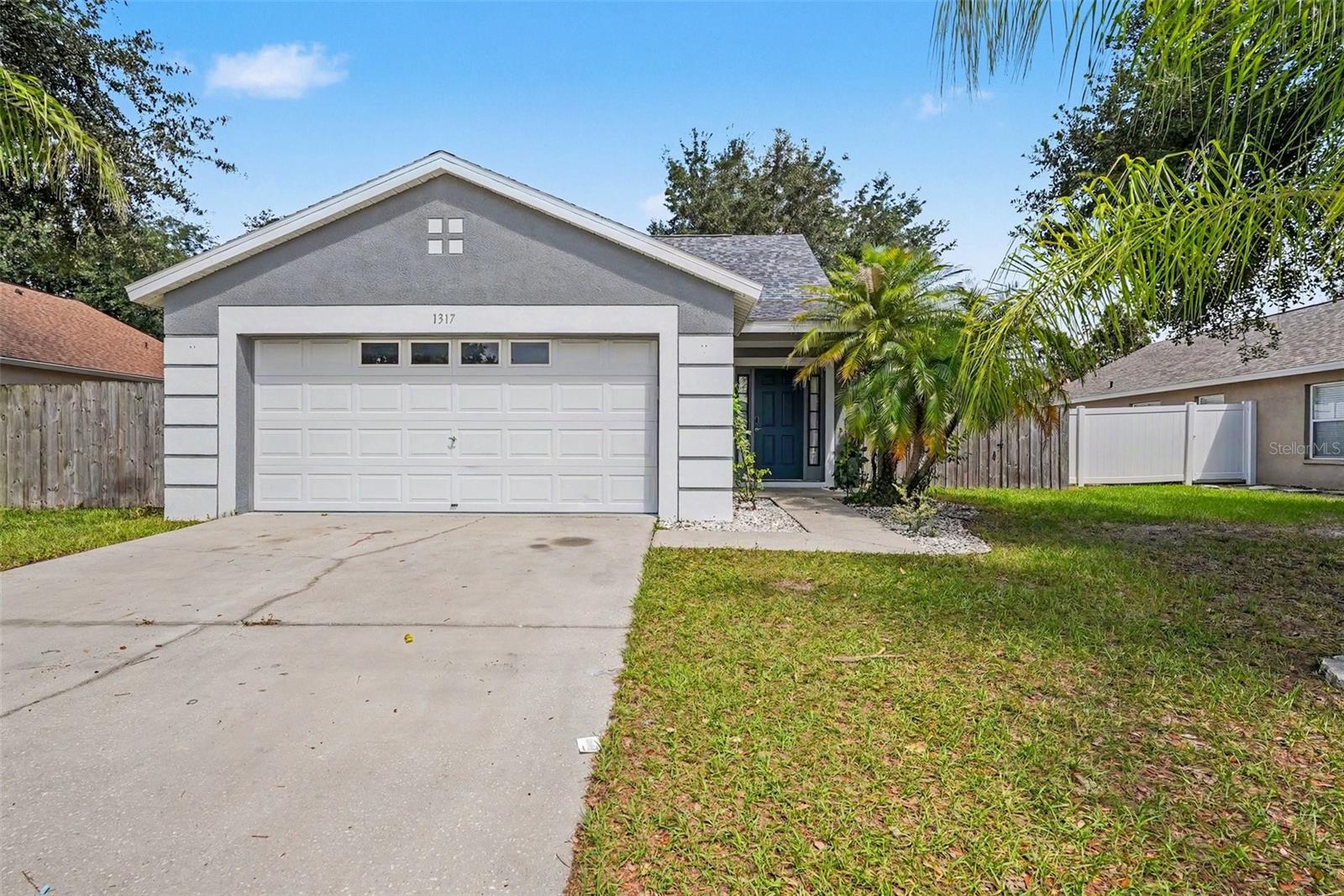 Welcome to 1317 Avonwood Court, a beautifully maintained 4-bedroom, 2-bath home in the highly sought-after Oak Grove community of Lutz. Offering 1,470 square feet of living space, this move-in-ready home combines major updates, low ownership costs, and an unbeatable location less than five minutes from Wesley Chapel.

Recent improvements include a NEW roof (2024), A/C (2018), water heater (2026), updated bathrooms (2025), and updated flooring (2018). With no carpet throughout, this home offers easy maintenance and modern appeal.

Inside, you'll find a bright, open layout, abundant natural light, and a spacious eat-in kitchen featuring bar seating, ample cabinet space, and ALL appliances are included. The kitchen flows seamlessly into the stunning Florida room addition completed in 2023, featuring walls of windows that overlook the private backyard and create the perfect flex space for entertaining, relaxing, working from home, or enjoying Florida's year-round sunshine.

Step outside to a fully fenced backyard shaded by beautiful mature oak trees that enhance the property without covering the roof. Fruit-producing plants and banana trees add charm and character, while the generous yard offers plenty of room for pets, gardening, or future outdoor living spaces.

Located less than one mile from SR 54 and under five minutes from Wesley Chapel's shopping, dining, hospitals, and I-75 access, this home delivers exceptional convenience without the extra costs. Enjoy NO CDD fees and a remarkably low HOA of just $245 per year.

Move-in ready, thoughtfully updated, and ideally located—this Oak Grove gem is ready for its next owner. Call today to schedule your personal tour!
