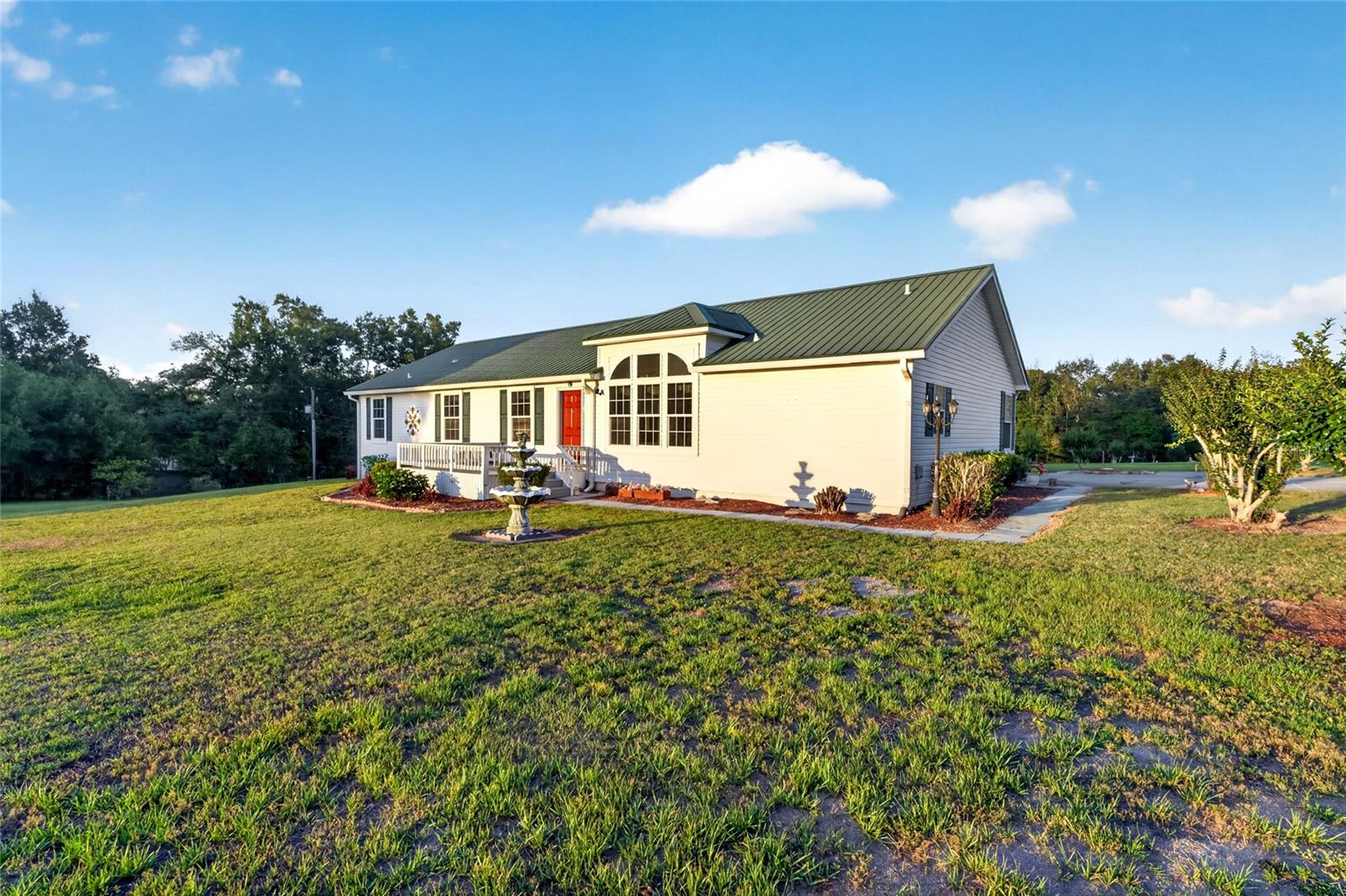 One or more photo(s) has been virtually staged. Country Living with Space, Updates & Endless Potential on 2.99 Acres! High and Dry! Welcome to 9712 US Hwy 301, Dade City, FL — a spacious 3 bedroom, 2 bathroom, 1 office home situated on 2.99 beautiful acres with a large barn, offering room to spread out while still being conveniently located! Inside, you’ll find both a living room and separate family room, providing plenty of space for relaxing, entertaining, or flexible living. Skylights throughout the home bring in beautiful natural light, creating a bright and inviting atmosphere. The home features vinyl laminate flooring throughout the living areas, kitchen, and laundry room, while the bedrooms have cozy carpet flooring.

The spacious primary suite includes a large bathroom with a soaking tub, perfect for unwinding after a long day. Enjoy peaceful mornings and evenings from the front porch, rear porch, or enclosed Florida room, all designed to take in the beauty of country living. 

Outside, the possibilities continue with a 24x30 barn, ideal for storage, hobbies, workshop space, animals, or equipment. With 2.99 acres, there’s plenty of room to enjoy outdoor living, gardening, or simply privacy and open space.

Major updates include a roof redone in 2018 and a new A/C installed in August 2025, giving added peace of mind. The home offers city water plus a private irrigation well, helping maintain the property while keeping watering costs down.

A rare bonus feature is the basement, offering amazing potential to be finished into additional living space, a game room, workshop, or extra storage!

Listed Property Features: 3 Bedrooms | 2 Bathrooms | 1 Flex Room | 2.99 Acres | Living Room + Family Room | Skylights Throughout | Vinyl Laminate Flooring in Main Areas | Laundry Room | Front Porch, Rear Porch & Florida Room | 24x30 Barn | Roof Redone in 2018 | New A/C (August 2025) | City Water + Irrigation Well | Partial Unfinished Basement with Endless Potential 

This unique property offers the perfect blend of space, comfort, and opportunity — schedule your private showing today! Also, If you are looking for a family compound or to expand, there is an adjacent parcel with home, barn, & in-law suite that is also for sale.