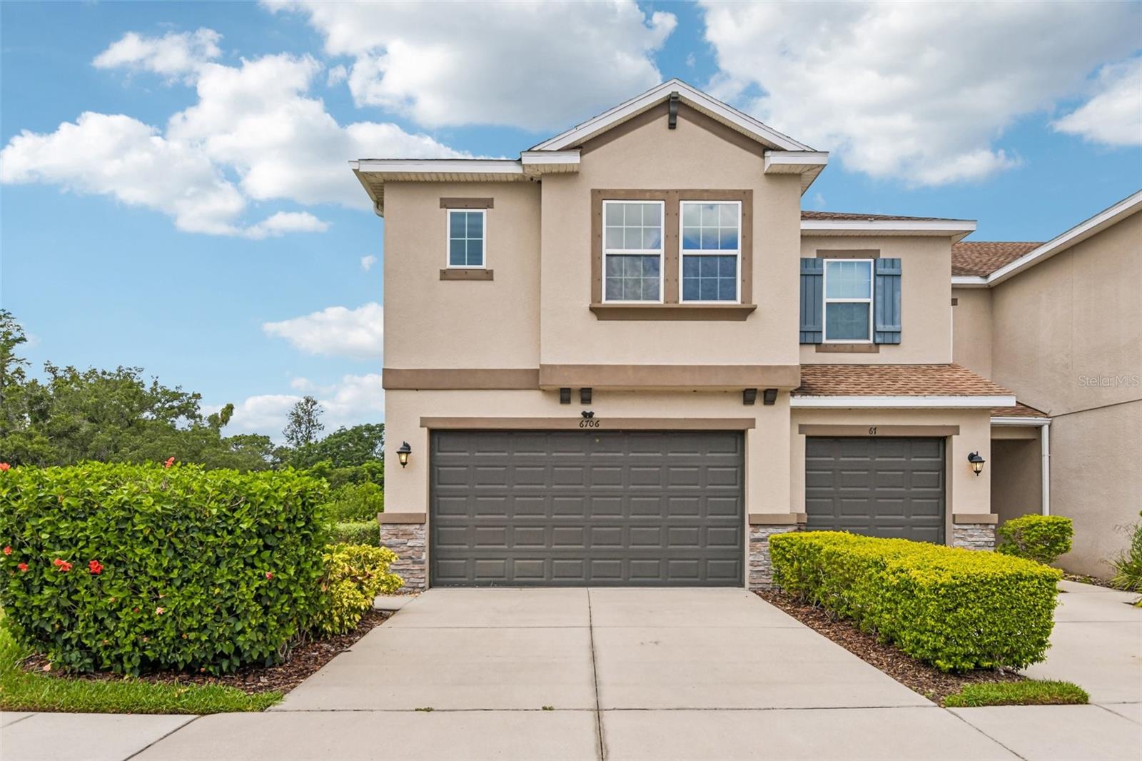 Virtually Staged. Experience modern living at its finest in this beautifully appointed, move-in-ready corner townhome, perfectly combining luxury, functionality, and an unbeatable location. It is ideally situated just minutes from the Veterans Expressway, Citrus Park Mall, shopping, and dining. This 3-bedroom, 2.5-bathroom home sits within a resort-style community with scenic green spaces. Inside, the spacious open layout features trendy 7x22 plank-style ceramic tile flooring throughout the first floor, highlighting a gourmet kitchen equipped with beautiful antique pearl quartz countertops, large 42" Cherry Java cabinets, and a generous pantry closet. The functional garage entry offers an additional cabinet and countertop station. A beautiful wooden spindle staircase with stained oak wood railings leads to the plush carpeted second floor, which hosts elegantly finished granite-countertop bathrooms and a versatile, large bonus loft ideal for an additional entertainment area. Designed with excellent storage solutions, including multiple linen closets, the primary suite includes a custom designed walk-in California Closet with built-in cabinetry and shelving. This end unit offers ultimate privacy with no rear neighbors. Instead, you can unwind and enjoy picturesque, peaceful views of a tree-filled conservation area from both your primary bedroom and the enclosed lanai. This exceptional home truly has it all. A well qualified buyer may assume the current 2.25% loan. Schedule your private tour today!