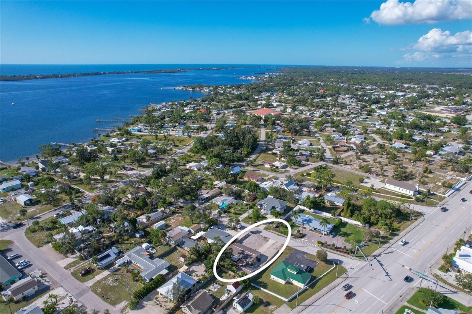 Motivated Seller! Less than three miles from the beach, this property is in the X flood zone and offers both a welcoming main home and a detached 320-square-foot efficiency apartment, making it the perfect setup for a family home with added income potential. Live in the main residence and rent out the guest cottage, or keep it for visiting family and friends. Outside you will find low-maintenance xeriscaping, a brand new garage door, and privacy fencing. Step inside the main home where there is easy care tile flooring throughout the main living areas and a kitchen with granite countertops, soft-close wood cabinetry, and plenty of storage. A cozy dinette sits just off the kitchen with sliding glass doors to the screened lanai, letting you open the home and enjoy salty coastal breezes flowing through the home. Both bedrooms have reach-in closets, while the shared bathroom has been updated with a granite vanity and a shower-tub combination. In the single-car garage there is a laundry area and a convenient half bath. The backyard is designed for outdoor living, complete with an oak shade tree, privacy hedge along the lanai, and a paver patio that’s ready for entertaining or quiet evenings outside. The detached efficiency cottage is a wonderful bonus. With tongue-and-groove ceilings that add warmth and character, this open layout combines living, dining, sleeping, and a kitchenette into one versatile space. A walk-in shower and single-sink vanity finish out the bathroom, making it ideal for generating rental income, creating a personal retreat, or accommodating multi-generational living. Located close to everything in Englewood you will be able to easily enjoy the weekly Farmer’s Market on Dearborn, listen to live music at one of the several tiki bars and restaurants after a trip to the beach, take in a ballgame at one of the two major league Spring Training Facilities, visit one of the many nature parks or hike the trails for exercise. No matter what you enjoy, you will find everything within close proximity. Venice Beach and Downtown is less than 15 miles away and Port Charlotte is less than 17 miles away, you will be right in the middle of all the hub and activity of the area, yet enjoy the privacy and small town charm Englewood provides.  Here, you’ll enjoy the privacy and small-town charm of Englewood with the convenience of nearby cities and attractions. This home with a guest cottage located at 25 1st Avenue truly combines lifestyle and opportunity. Schedule your showing today and see for yourself everything it has to offer.