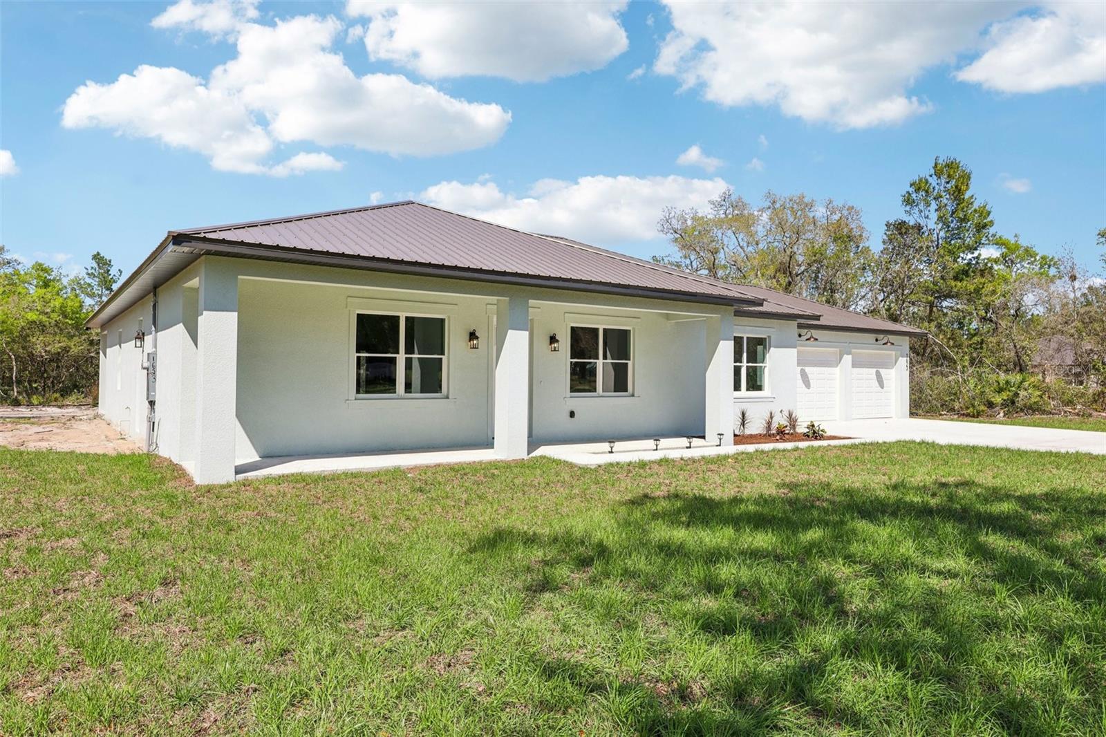 Final details are happening on this New construction 3250 SQF home with 4 Bedroom 4 Bathroom 3 car garage on a 4.31  acre A3 zoned lot that allows horses, chickens, cattle etc. Property offers plenty of land for additional clearing to put in a pool or other out buildings.  Huge open floor plan with chef style kitchen with 36" electric FORNO stainless range and hood. Surround sound in family room. Huge command center/utility room with microwave and extra refrigerator.  Giant 10 by 50 rear patio where you can enjoy the 4 plus acres that back up to conservation easement.  The 4.31 acres is tucked in back of one of DeLand's well established neighborhoods. So bring all the toys and enjoy country style Florida living. 15 minutes to the Daytona Speedway and minutes to shopping and down town DeLand.