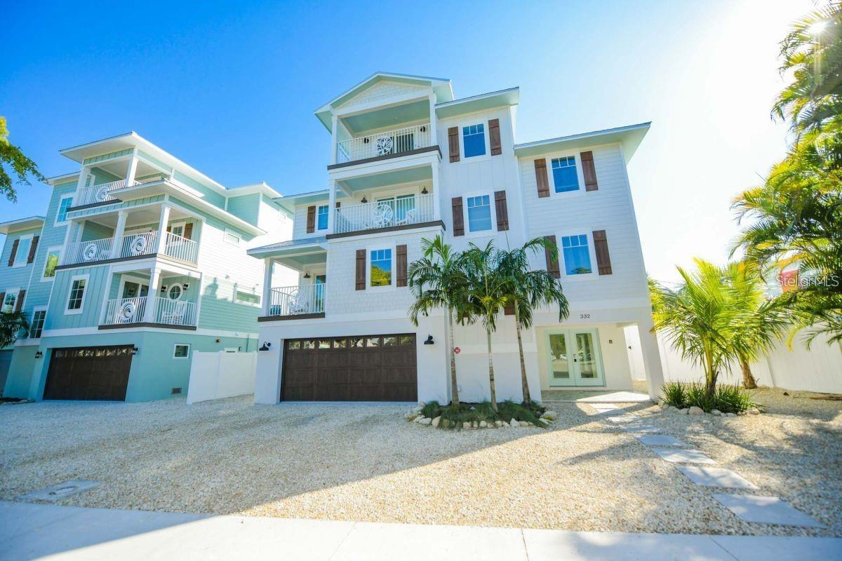 ~Experience elevated coastal living in this fantastic BEACH HOUSE right in the heart of SIESTA KEY VILLAGE~ This beautiful home boasts 8 bedrooms + an additional bonus room = 9, plus 8 bathrooms, including 6 en-suite retreats, perfectly suited for a large primary residence or a high-performing luxury vacation rental. 
Ideally located and just steps from premier dining, boutique shopping, & vibrant nightlife, and only a short stroll or bike ride to the world-renowned Siesta Key Beach. This property offers the ultimate blend of convenience with the feel of a resort-style escape. Upon entering take the stairs or the convenient elevator up to the main living space. Here you will find an open chef's kitchen, large island, a beverage bar, along with the spacious living room and dining area. There are 2 bedrooms also on this level. Multiple balconies showcase great views of the village, while the home’s prime location places you moments from everything Siesta Key has to offer. It has been thoughtfully designed with high-end designer finishes and furnishings, every detail for both comfort and entertaining. The bonus room on the 4th level leads out to a spiral staircase and then up to the rooftop deck where both village and GULF VIEWS create a great backdrop for stunning SIESTA SUNSETS. 
Back on the 1st level, walk out to the covered patio and enjoy your private outdoor oasis with lush landscaping and the tranquil heated pool & spa designed for both relaxation and entertainment. It features an oversized sun shelf, wraparound lounge ledge and in-water bar seating. 
Whether you're hosting family and friends, a large group getaway or seeking a luxury investment property, this extraordinary beach house delivers unmatched living spaces throughout. It also comes beautifully turnkey furnished and ready for immediate enjoyment or rental income. THIS IS YOUR COASTAL ESCAPE...where luxury, location, and lifestyle all meet!