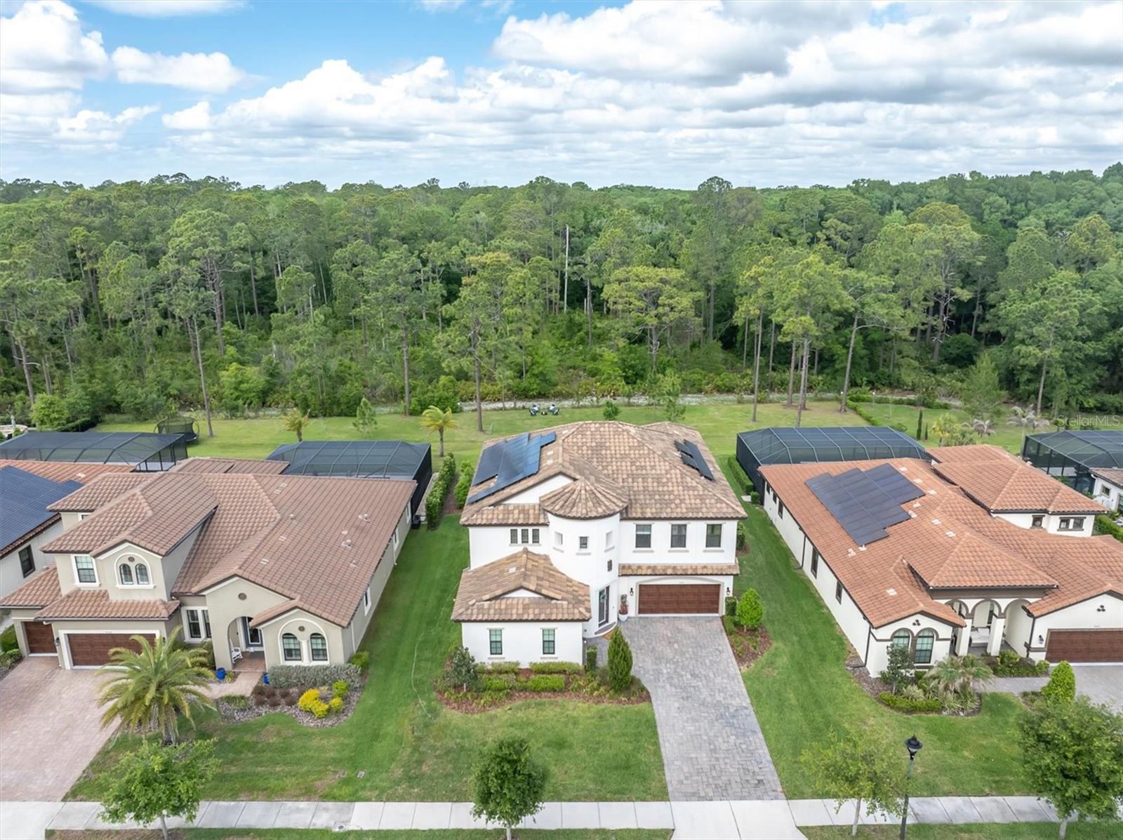 NEW PRICE! Welcome to a luxury estate in the coveted gated section of Anclote Reserve At Starkey Ranch a Tampa Bay award winning master planned community. This exceptional Madeira III by WestBay Homes sits on one of the few expanded homesites in the entire community — an impressive .40-acre cleared lot backing directly to the serene Starkey Wilderness Preserve, offering unmatched privacy and breathtaking natural views.
This expansive residence offers 5 bedrooms, 4.5 bathrooms, and over 4,200 square feet of living space, blending luxury, functionality, and energy efficiency. The home features a fully paid-in-full solar system with 104% power offset using REC panels valued at approximately $60,000 — delivering the rare benefit of virtually no electric bill.
Step into your private resort-style backyard oasis designed for ultimate relaxation and entertaining. Enjoy a saltwater pool and heated spa powered by a 400K Pentair heater with seven jets and a tranquil water feature. The outdoor space is finished with beautiful travertine decking, landscape rock accents, gutters in the backyard and over the pool equipment area, and a premium Canadian Timber Collection cedar sauna featuring a 7-kilowatt Harvia heater, hardwired to electric and designed to accommodate up to eight people, valued at approximately $20,000.
Inside, you are welcomed by grand two-story ceilings, elegant crown molding in the foyer, tray ceilings, and designer lighting throughout the main living areas, including custom fixtures from Pottery Barn. The living room features a custom stone accent wall, built-in ceiling speakers, and remote-controlled custom window shades, creating both comfort and sophistication.
The gourmet kitchen is a showpiece, featuring quartz countertops with extended seating, tiled backsplash, extended cabinetry with glass showcase display, gold hardware and faucets, reverse osmosis system, and a spacious layout perfect for entertaining. The thoughtfully designed floor plan includes a first-floor bedroom with a private full bath, ideal for guests, in-law quarters, or a secondary owner’s suite, along with a den or office with glass double doors and a beautifully designed drop zone with tile flooring for everyday convenience.
Additional upgrades throughout the home include a water softener system, tankless water heater, CAT 6 internet pre-wiring, 3-ton AC units, custom rods, curtains, and shades that convey, and a spacious laundry room complete with folding table and built-in drawers. Upstairs, the home features a Jack-and-Jill bathroom and generous secondary bedrooms, while the luxurious owner’s retreat showcases crown molding, black quartz countertops with gold accents, and a large garden soaking tub creating a spa-like atmosphere.
The backyard is thoughtfully designed with cleared land maximizing space while maintaining the natural beauty of the preserve setting. This rare estate offers luxury finishes, energy efficiency, resort-style outdoor living, and one of the largest homesites in Starkey Ranch — all within a private gated enclave. Experience elevated Florida living at its finest.
The community includes multiple parks, playgrounds, pools, kids splash zone, magnet K-8 elementary middle school, county library, starkey ranch district park,tennis, and over 20 miles of walking/biking trails. Conveniences include grocery, restaurants,nails and hair salon and a neighborhood favorite starkey market.