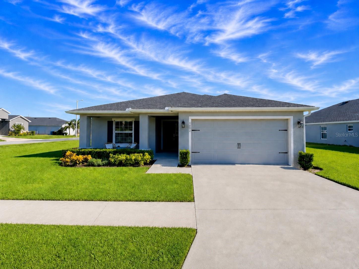 This stunning one-story home sits on 1,819 sq ft of beautiful living space! The 4-bedroom and 2-bath gem features an open-concept layout highlighted by a gorgeous kitchen with stone gray shaker-style cabinets with crown molding, Samsung stainless steel appliances, a walk-in pantry, and a spacious counter-height island that flows into the dining cafe and gathering room. Premium upgrades elevate this home, including luxury wood vinyl plank flooring throughout the main areas, stain-resistant bedroom carpets, a custom living room chandelier, and elegant dining and bedroom chandeliers.
The split floor plan places the owner's suite as a private retreat, complete with a walk-in wardrobe and an en-suite bath featuring dual vanities, a tiled shower, and a filtered water shower head. Enjoy tech and entertainment upgrades which includes a Ring doorbell and a clean-mounted Frame TV with a custom frame included. Outside, relax in your screened lanai overlooking a fully fenced backyard. Complete with custom window blinds, a 2-car garage, architectural shingles, and energy-efficient construction. This home is walking distance to some of the most beautiful lakes in Lake Alfred, the historic Mackay Gardens and Lakeside Preserve, a playground, and nearby schools. Downtown Lake Alfred is 2 minutes away. Schedule your showing today!