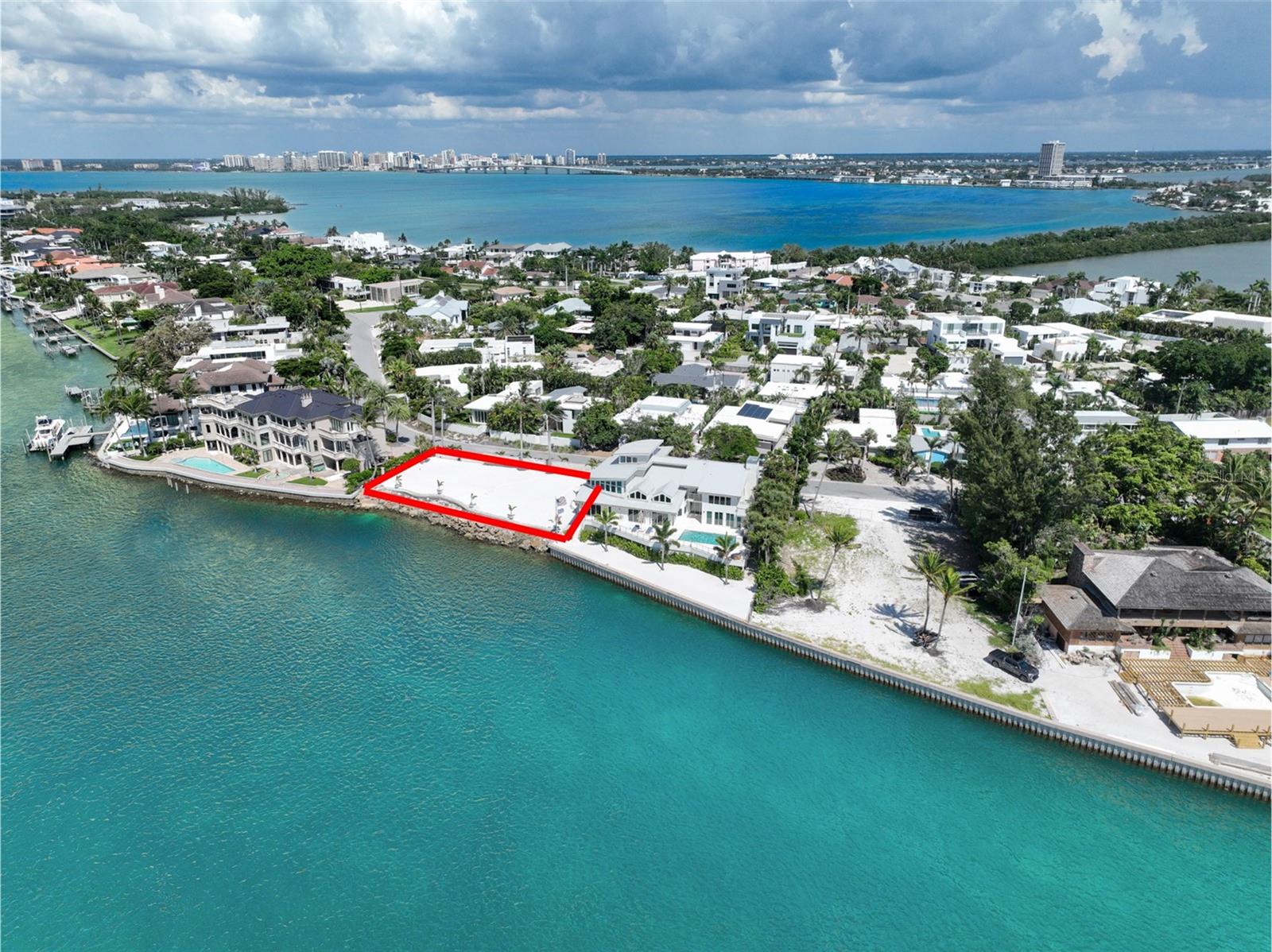 COMMAND YOUR LEGACY - 143 FEET OF PRISTINE GULF FRONTAGE AWAITS YOUR VISION ON EXCLUSIVE LIDO KEY | A rare Gulf-front canvas awaits the discerning individual who  is ready to craft their legacy retreat at 1215 Westway Drive, positioned on the coveted Gulf side of Lido Key within the exclusive Lido Shores enclave with its own private beach access. This exceptional cleared and construction-ready parcel presents an unparalleled opportunity to architect your vision of coastal sophistication from the ground up, commanding 143 linear feet of prime Gulf frontage with unobstructed panoramic water views and legendary Sarasota sunsets. The generous parcel size at nearly 12,000 sq ft (.27 acre) arrives meticulously prepared for your bespoke oceanfront estate, complete with a thoughtfully designed perimeter stone-faced wall and gates ensuring absolute privacy, professionally enhanced landscaping establishing refined curb appeal, and an approved seawall permit that will maximize both functionality and aesthetic impact of this extraordinary waterfront position. Our curated network of premier architects and custom builders stands ready to collaborate with you in realizing a residence that reflects your distinctive taste and lifestyle—whether that vision encompasses expansive entertaining spaces with walls of glass capturing endless Gulf vistas, a private wellness sanctuary, chef-caliber culinary environments, or resort-style outdoor living areas designed for the ultimate in oceanfront luxury. This is the exceptionally rare opportunity for accomplished individuals who understand that true luxury lies not in acquiring what exists, but in creating something entirely your own—a singular Gulf-front masterpiece on one of Florida's most prestigious barrier islands, where your oceanfront dream transforms from vision to reality under your direction and specification.