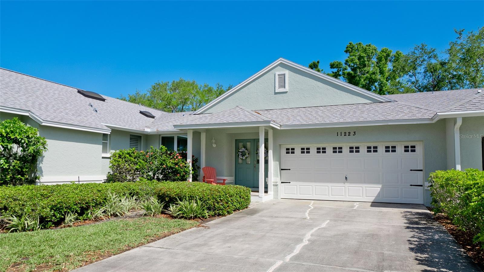 Perico Island - Experience peace and tranquility in this beautifully furnished, two-bedroom, two bath villa-style condominium featuring a split floor plan with soaring cathedral ceilings that create a bright, open atmosphere. A welcoming front porch leads to elegant double doors, opening to a foyer that flows seamlessly into the spacious living and dining areas. The well-appointed kitchen features ample counter space, cabinetry with pantry storage, laundry closet, and additional space for a breakfast nook or sitting area.  Sliding glass doors open to a serene Florida room overlooking a wooded view of Robinson Preserve, offering a private, nature filled atmosphere. Key updates include hurricane impact windows appliances, hot water heater, and air conditioning system - all less than 5 years old. The two-car garage includes a loft, providing additional storage space.  Ideally located near Robinson, Perico, and Neal Preserves, and just a short drive or bike ride to the stunning beaches of Anna Maria Island. Don't miss this rare opportunity - schedule your private showing today!